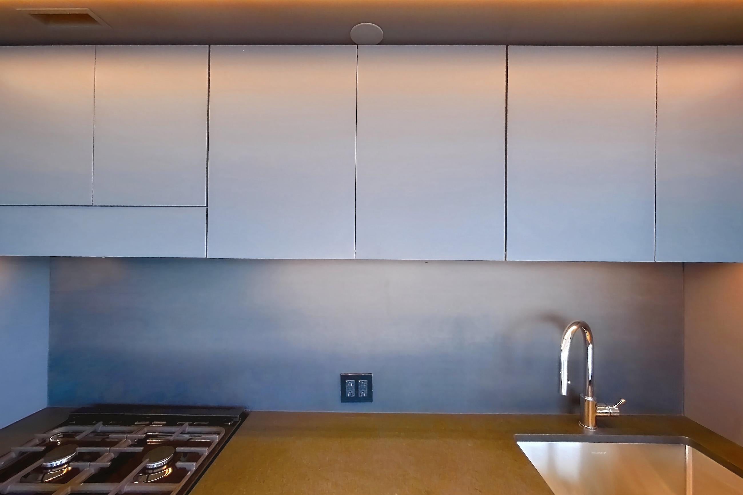 Kitchen with gas range, light wood-finish flooring, oven/range, and stainless steel appliances, Apartment 1-2604 at Eagle + West