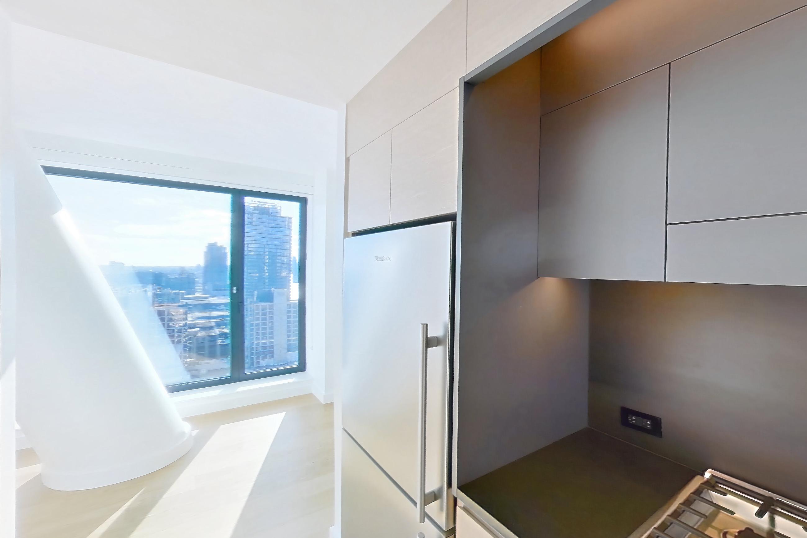 Kitchen with gas range, light wood-finish flooring, oven/range, and stainless steel appliances, Apartment 1-2508 at Eagle + West