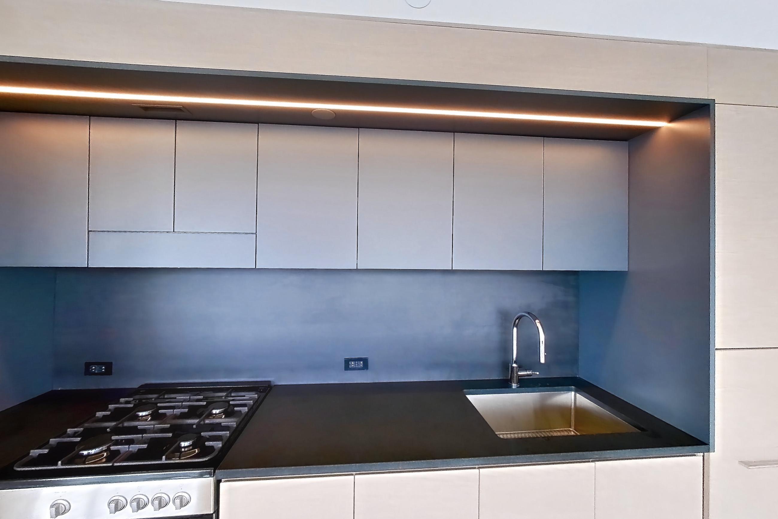 Kitchen with gas range, light wood-finish flooring, oven/range, and stainless steel appliances, Apartment 1-2501 at Eagle + West