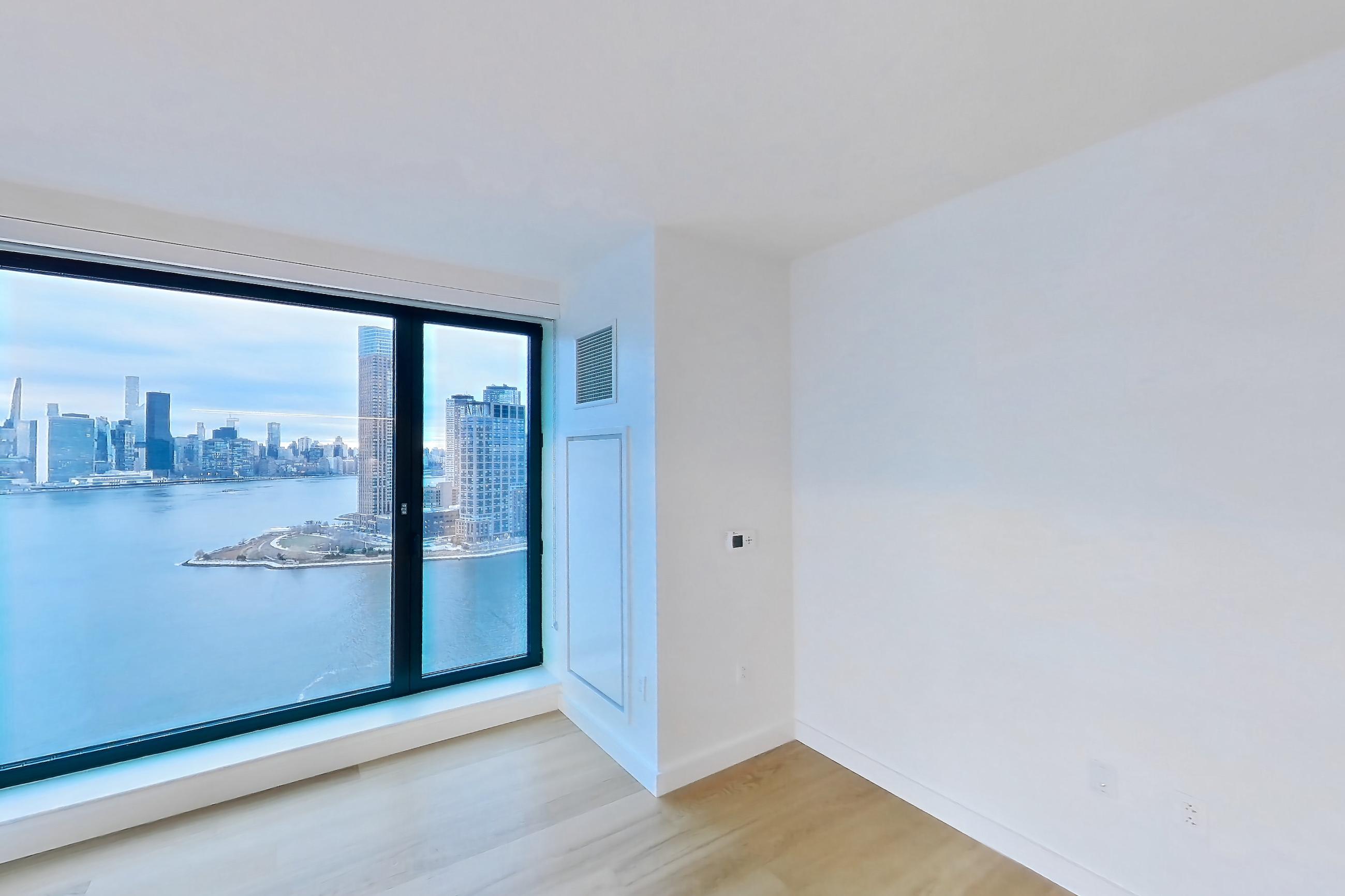 Living room with light wood-finish flooring, Apartment 1-2304 at Eagle + West