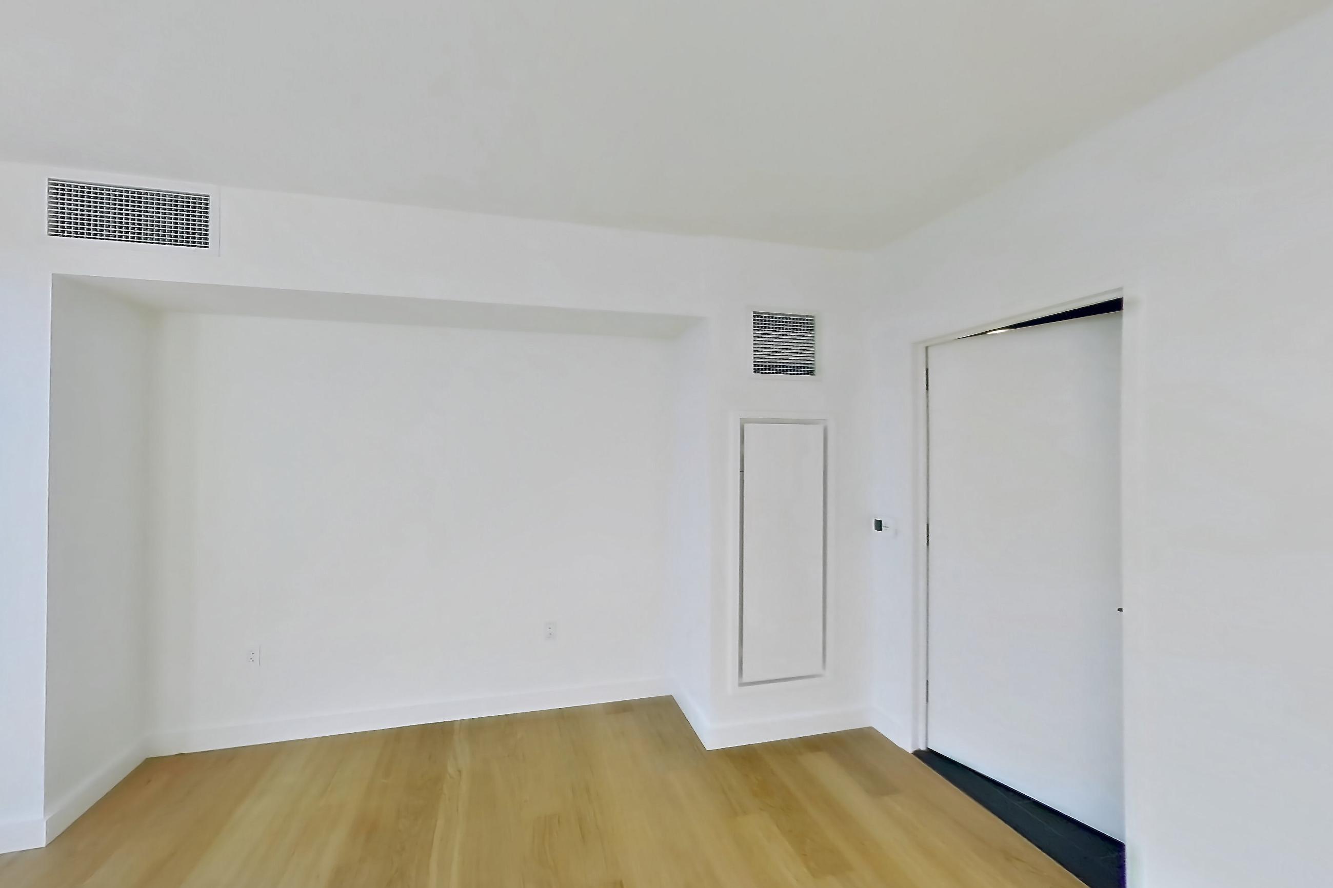 Living space with light wood-finish flooring and water view, Apartment 1-1801 at Eagle + West