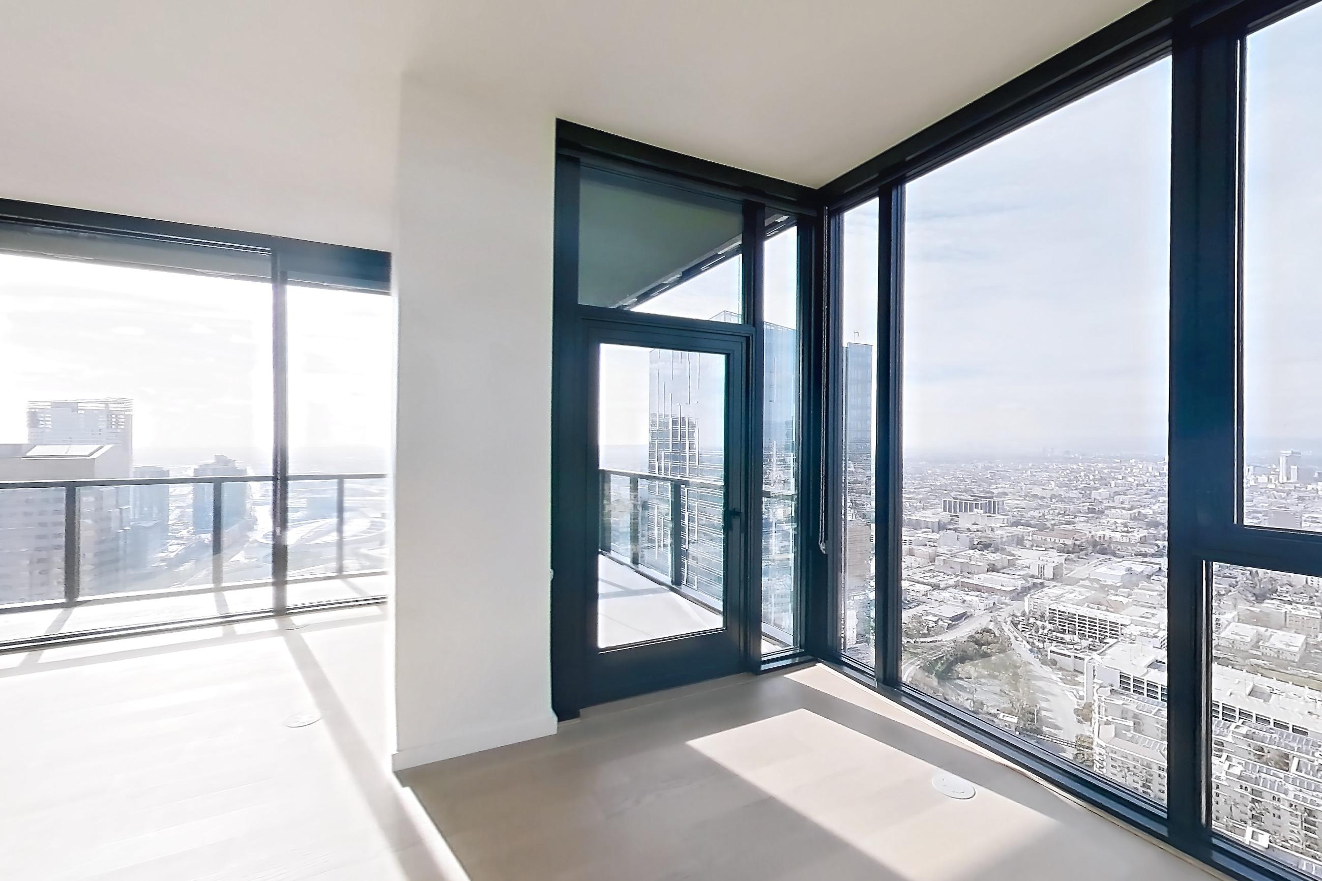 Living area with city view and light wood-finish flooring, Apartment 4801 - VIEW at Beaudry