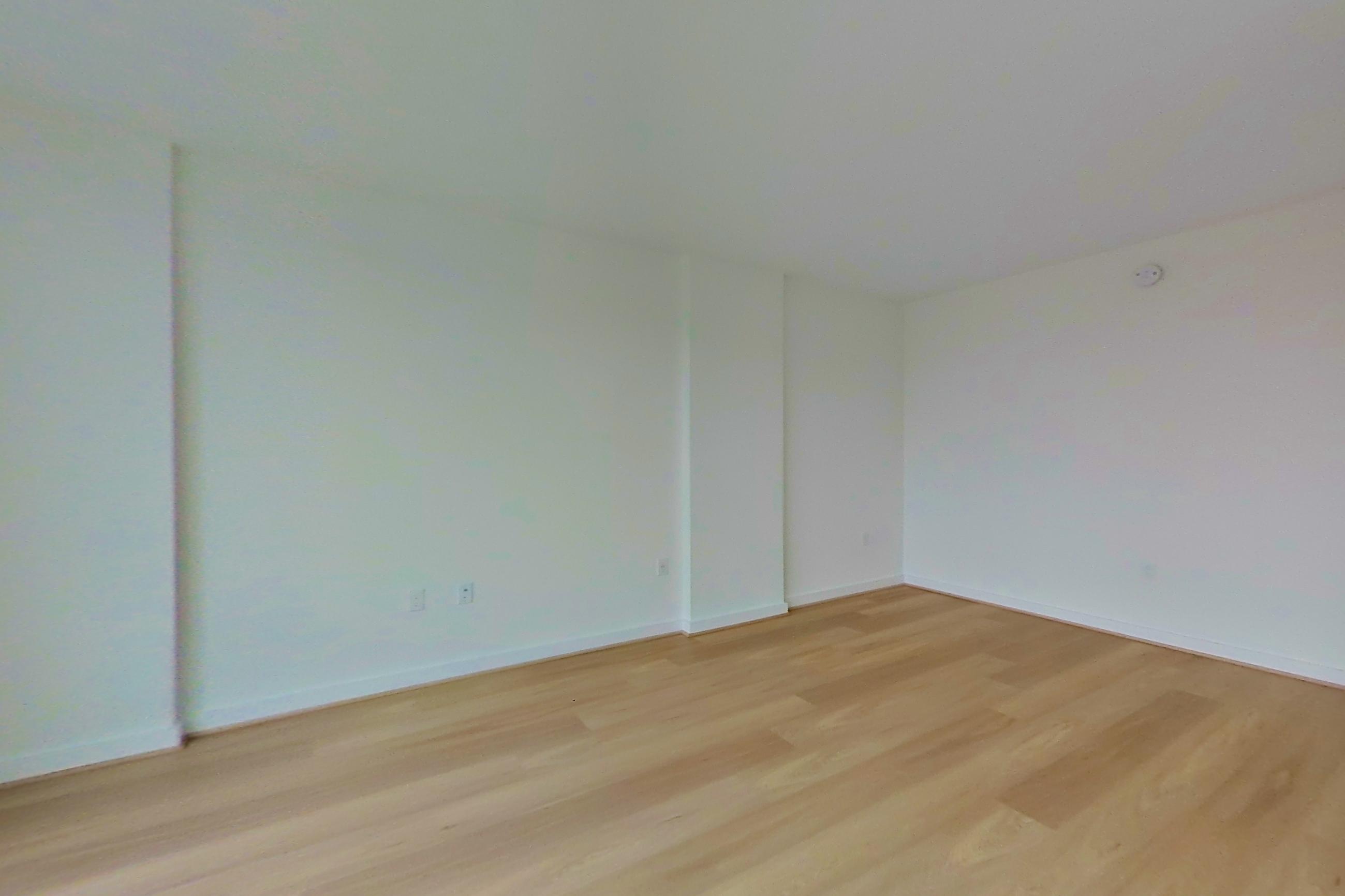 Living room with light wood-finish flooring, Apartment 0434 at Gallery 64