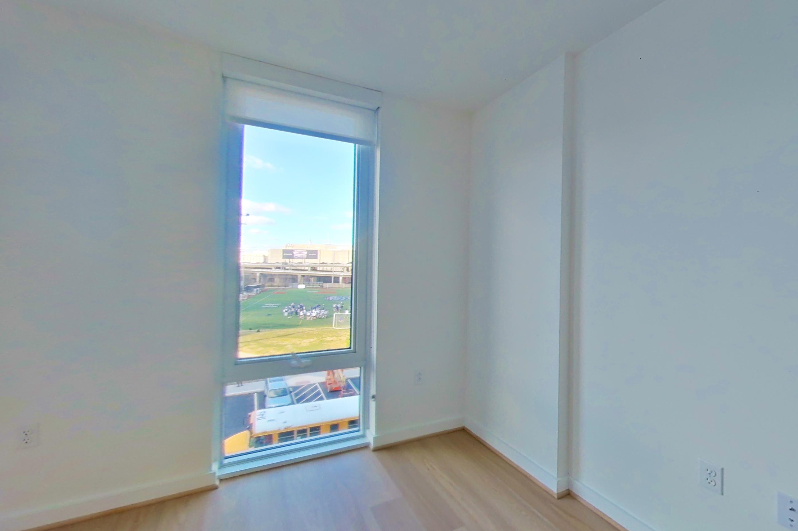 Living room with light wood-finish flooring, Apartment 0534 at Gallery 64