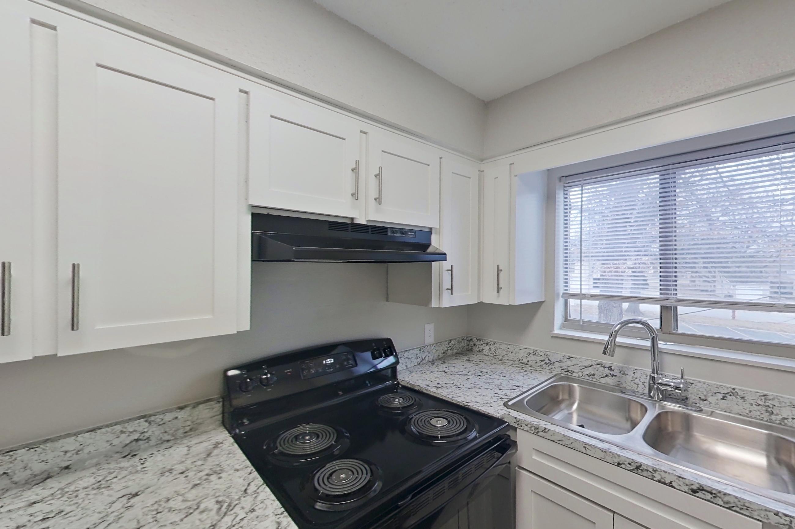 Kitchen in a 2x2 C Elite floor plan apartment, representative of Apartment 1412D at The Life at Legacy Fountains