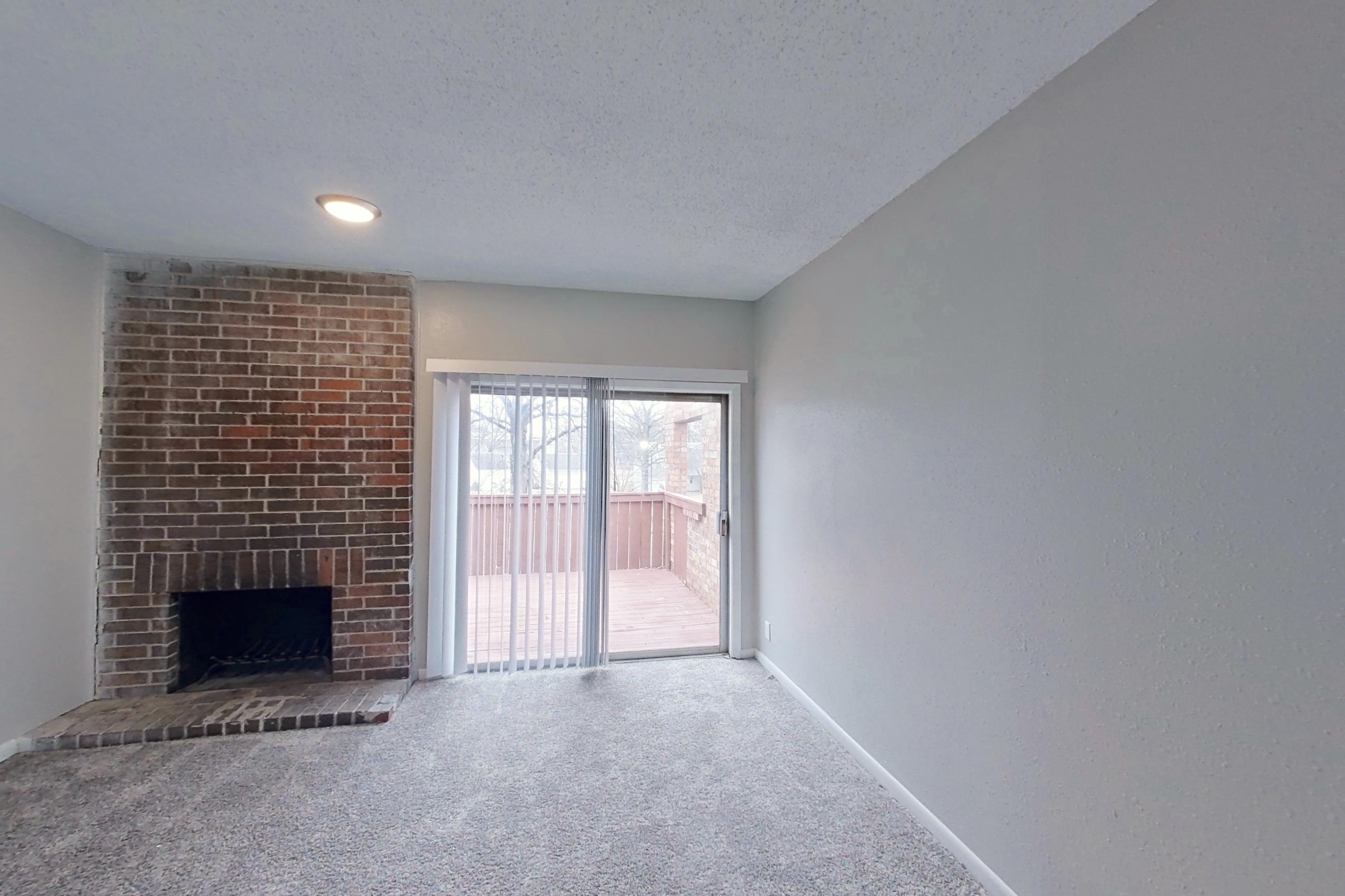Living room with brick fireplace and fireplace, Apartment 1402D at The Life at Legacy Fountains