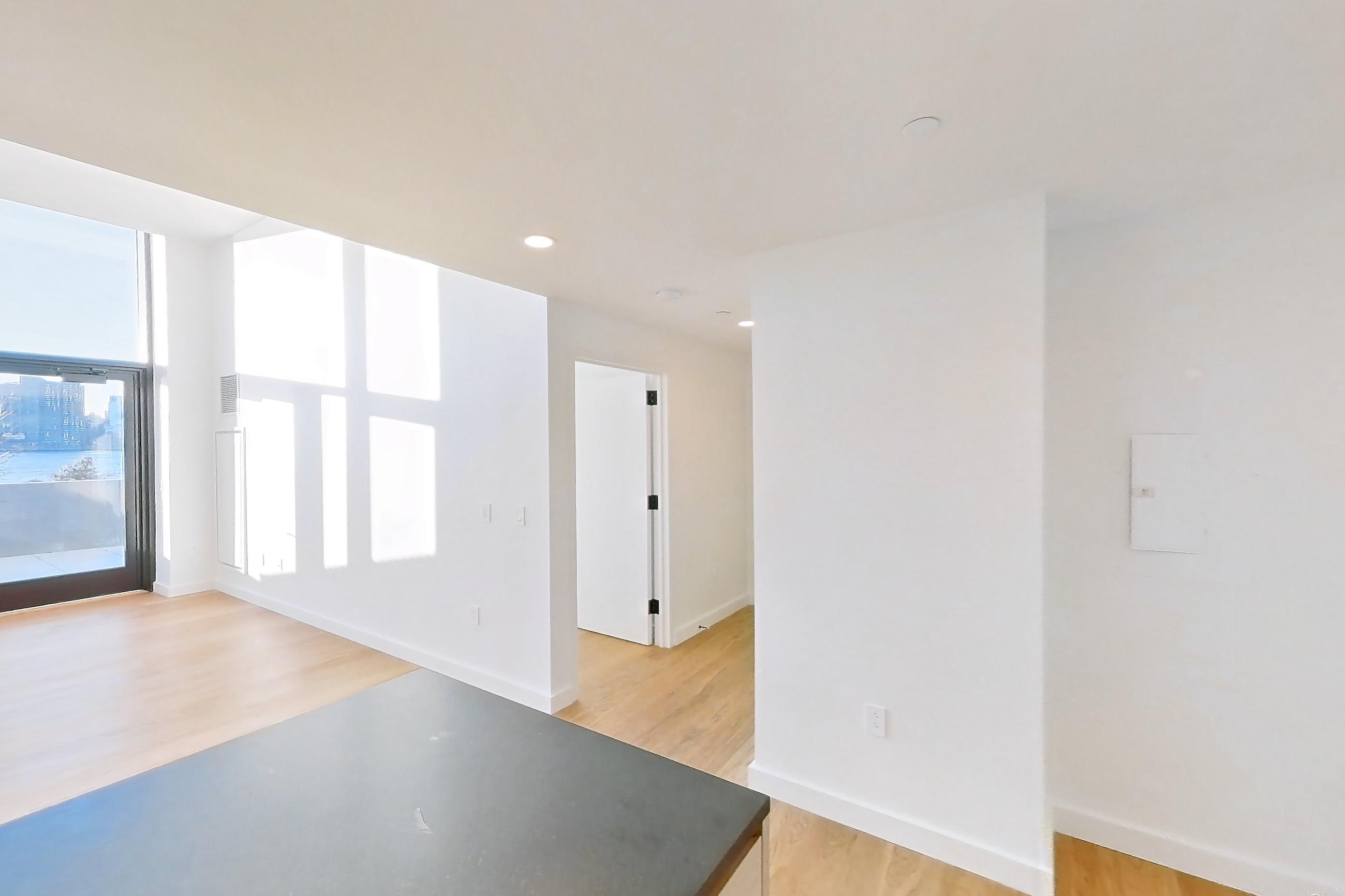 Kitchen with gas range and light wood-finish flooring, Apartment 1-1002 at Cortland Rosslyn