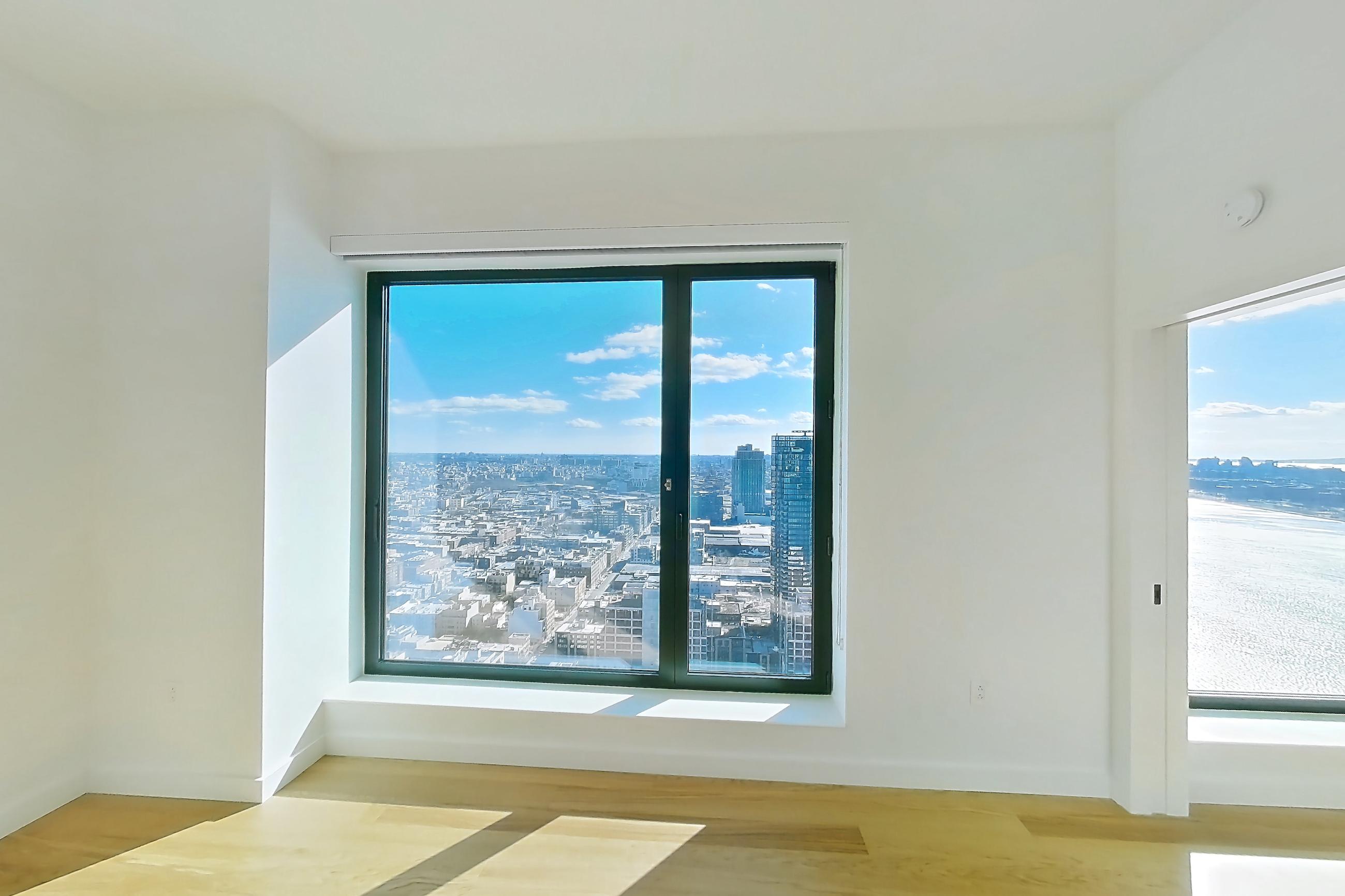 Living room with city view, ocean view, and water view, Apartment 1-PH1G at Eagle + West