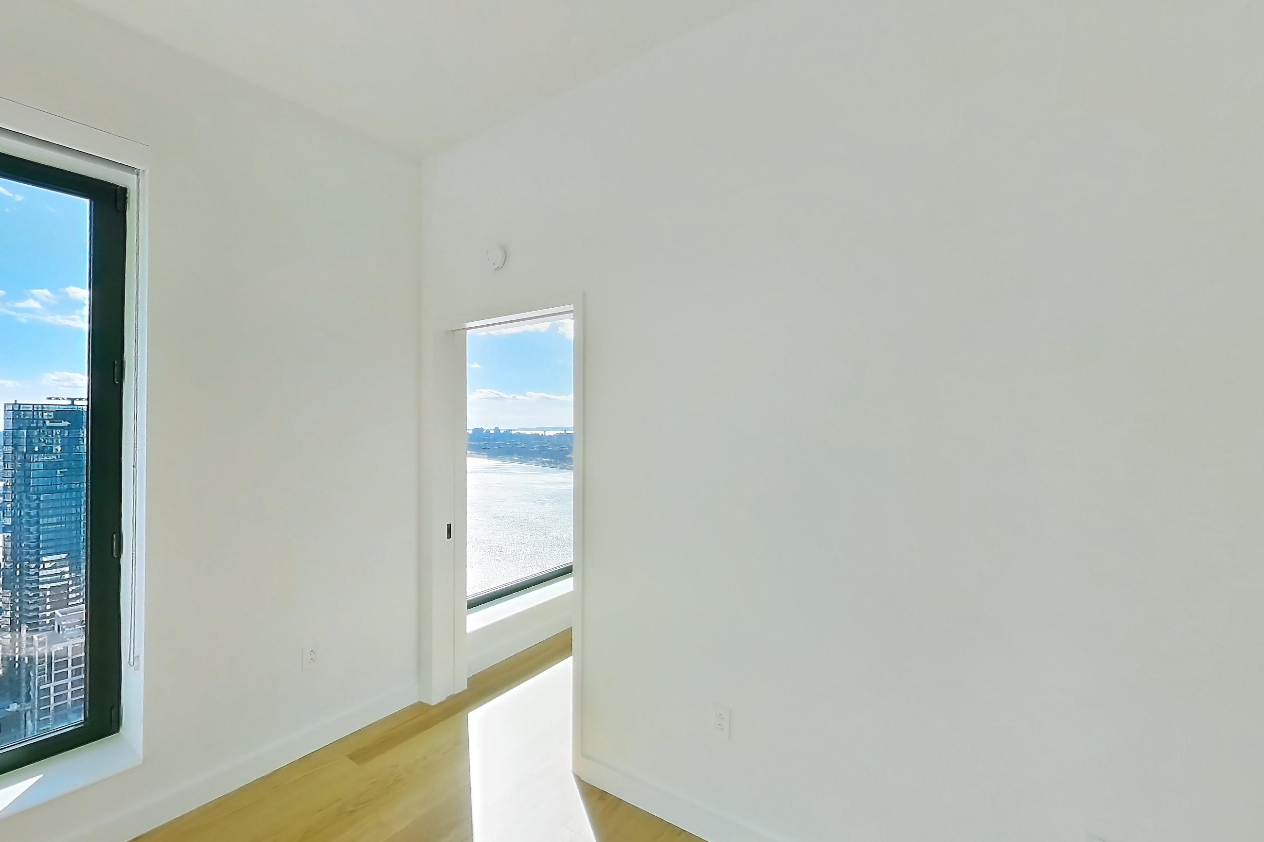 Living room with city view, ocean view, and water view, Apartment 1-PH1G at Eagle + West