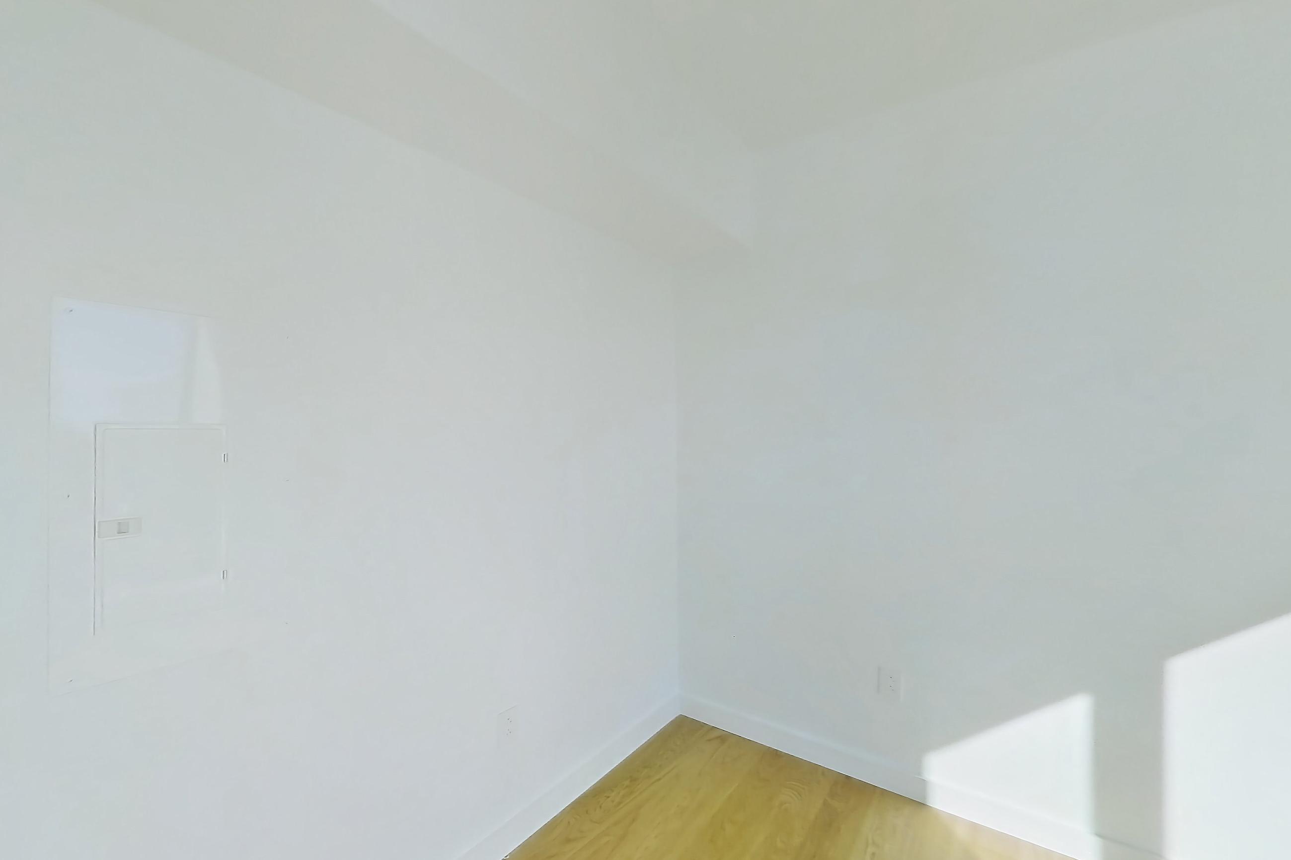 Living room with city view and light wood-finish flooring, Apartment 1-PH2G at Eagle + West