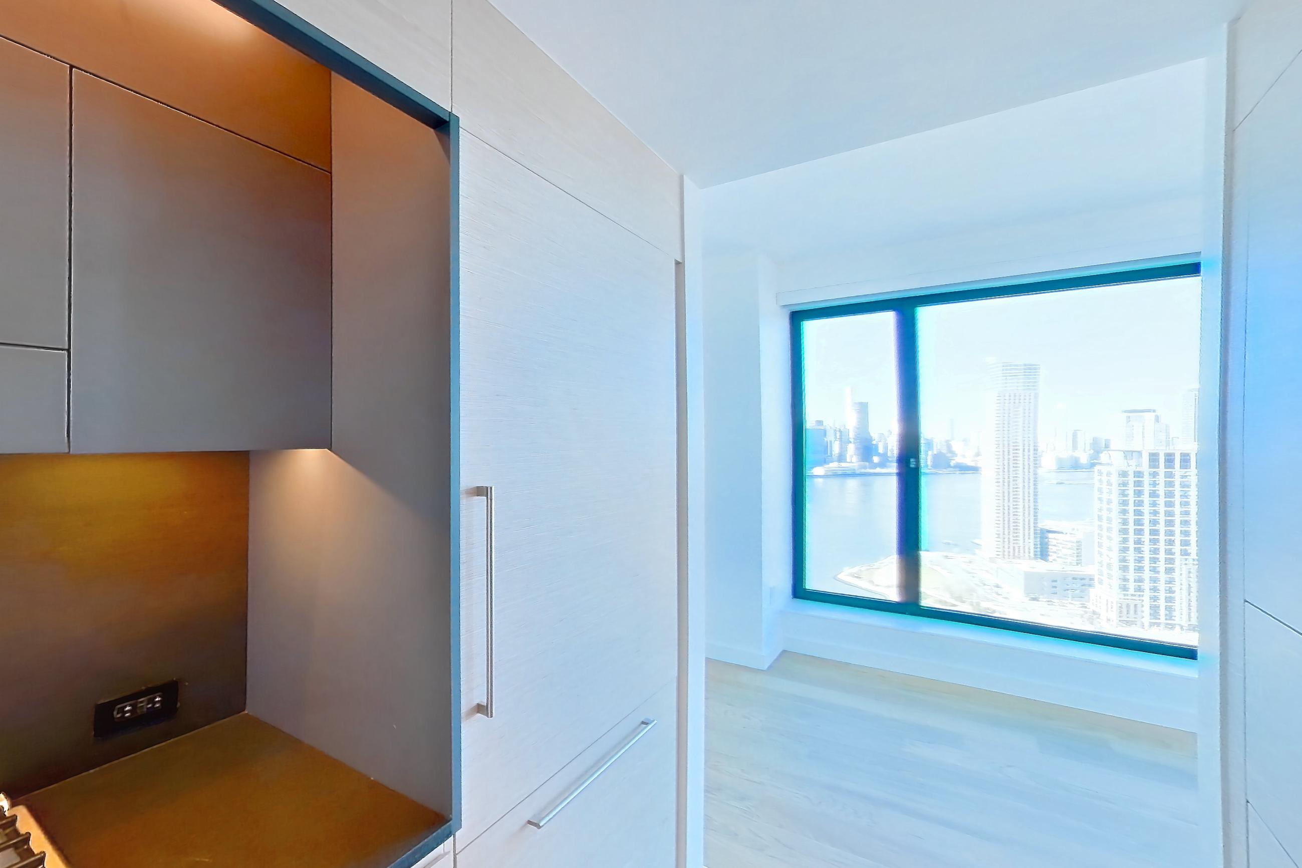 Kitchen with gas range, light wood-finish flooring, oven/range, and stainless steel appliances, Apartment 1-PH2E at Eagle + West