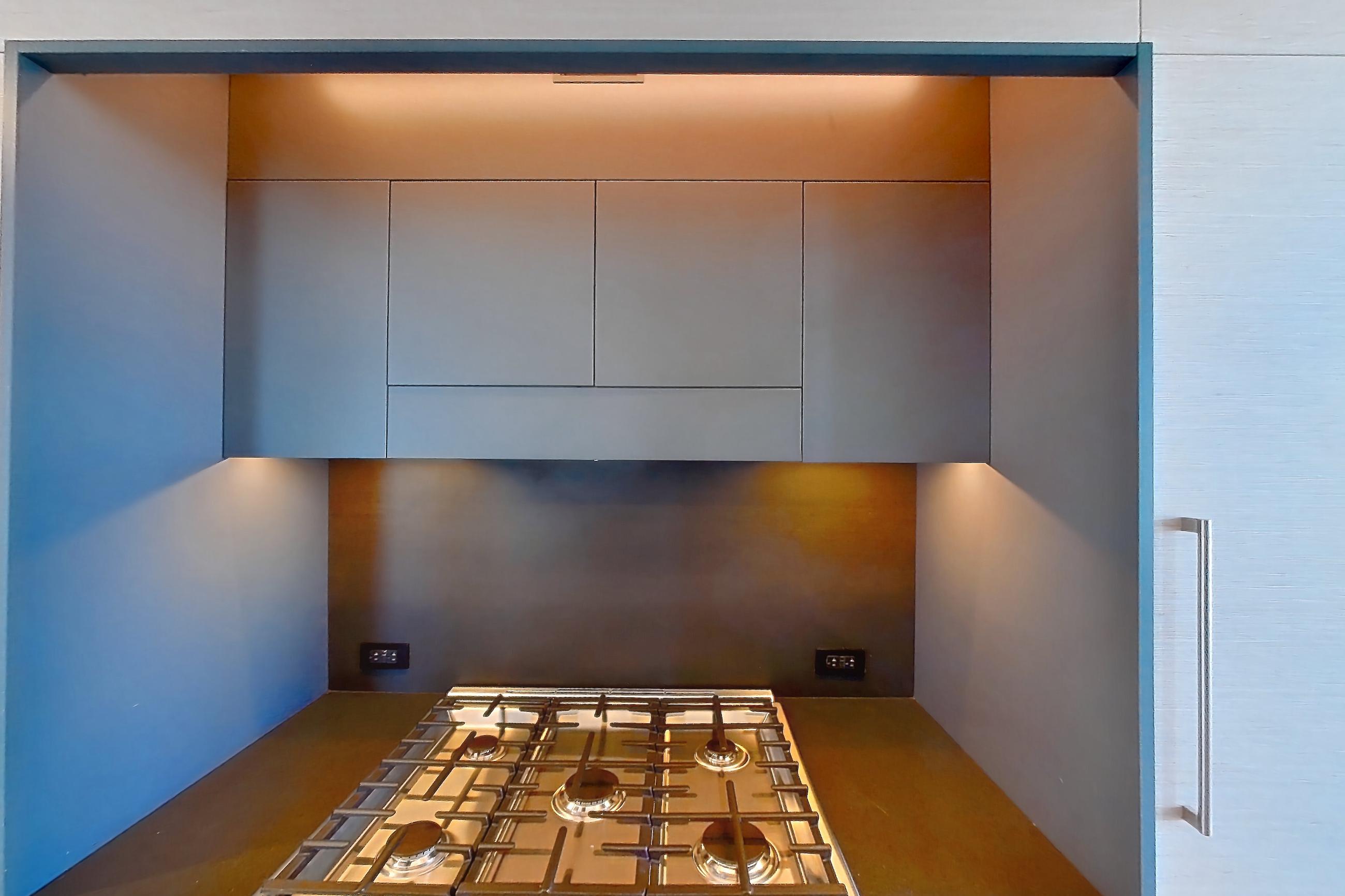 Kitchen with gas range, light wood-finish flooring, oven/range, and stainless steel appliances, Apartment 1-PH2E at Eagle + West