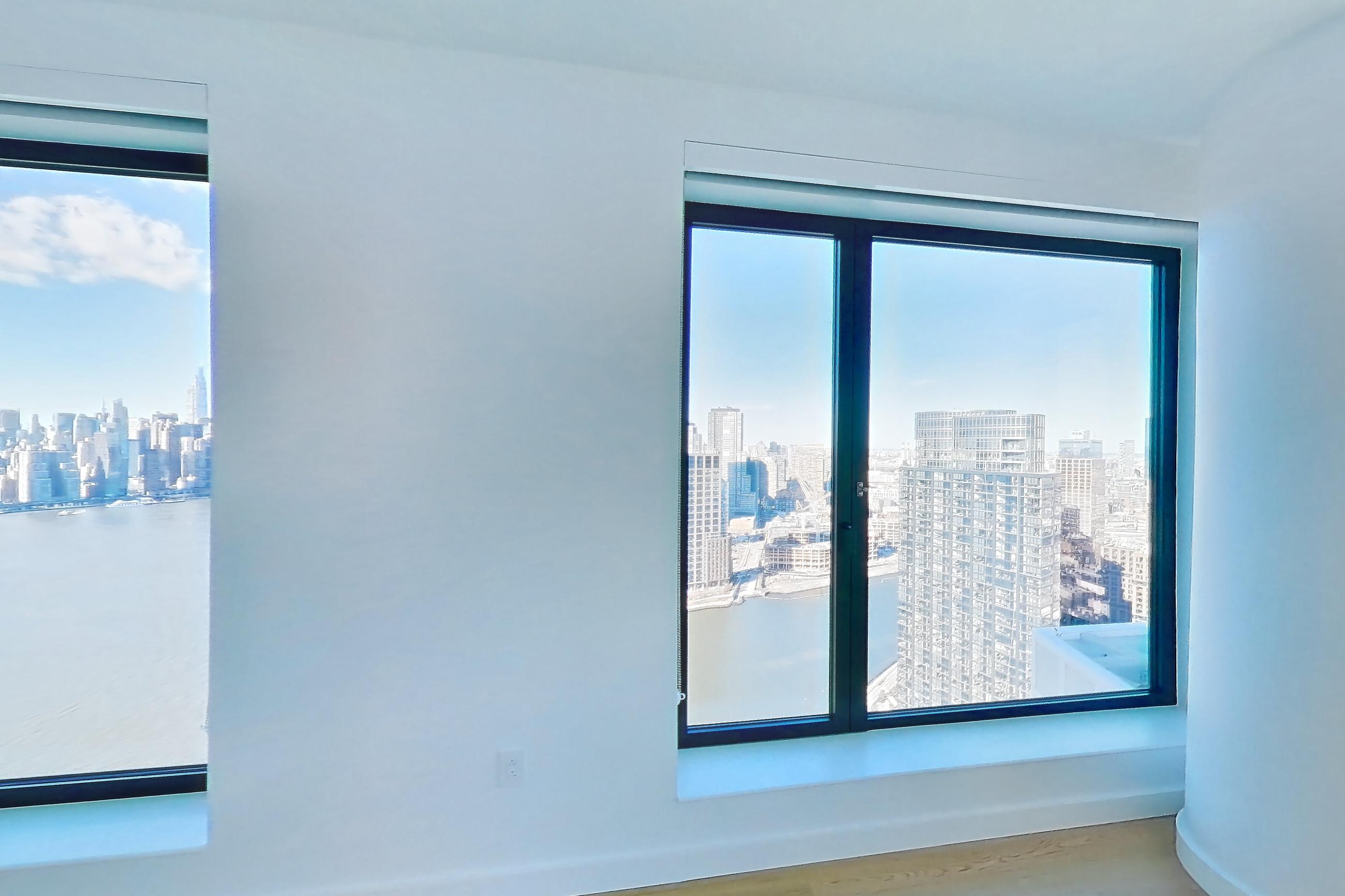 Living room with city view, Apartment 1-PH2E at Eagle + West