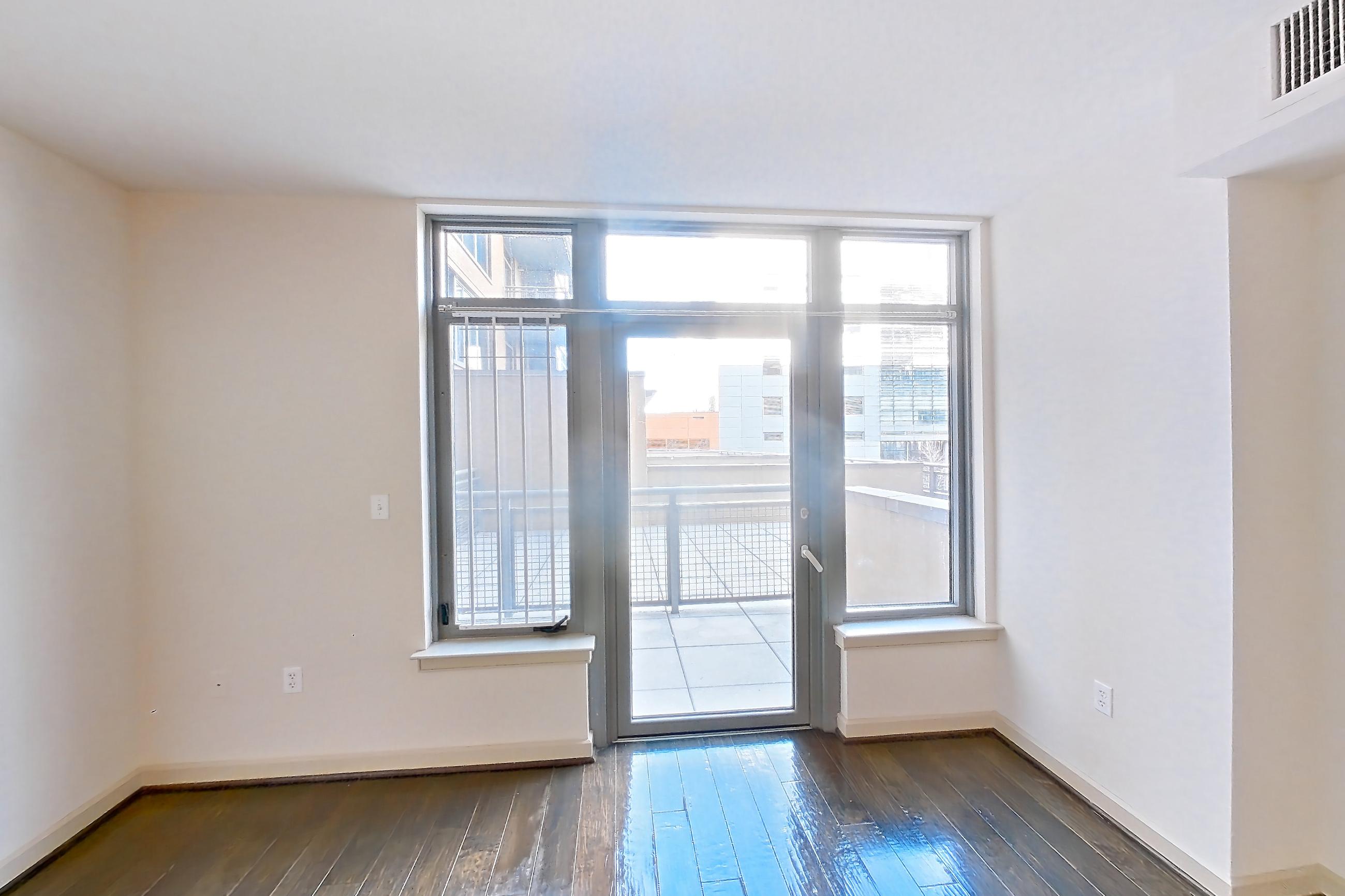Living room with wood-finish flooring, Apartment 0413 at The Cameron