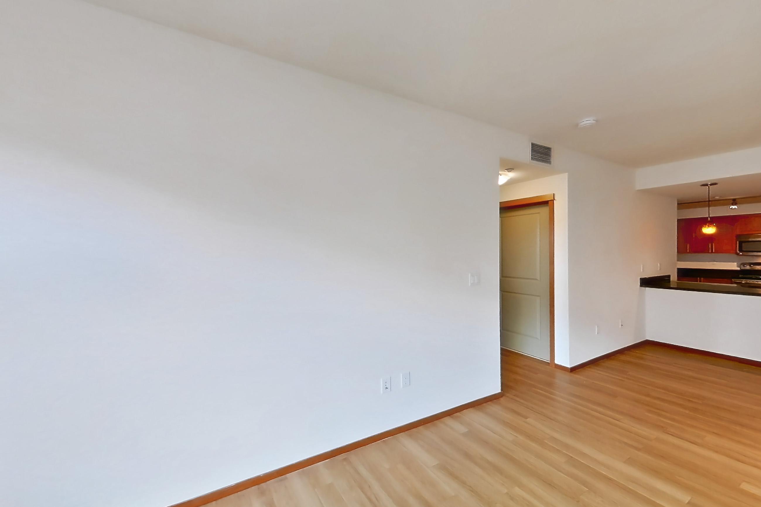 Living room with light wood-finish flooring, Apartment A319 at 77 Central