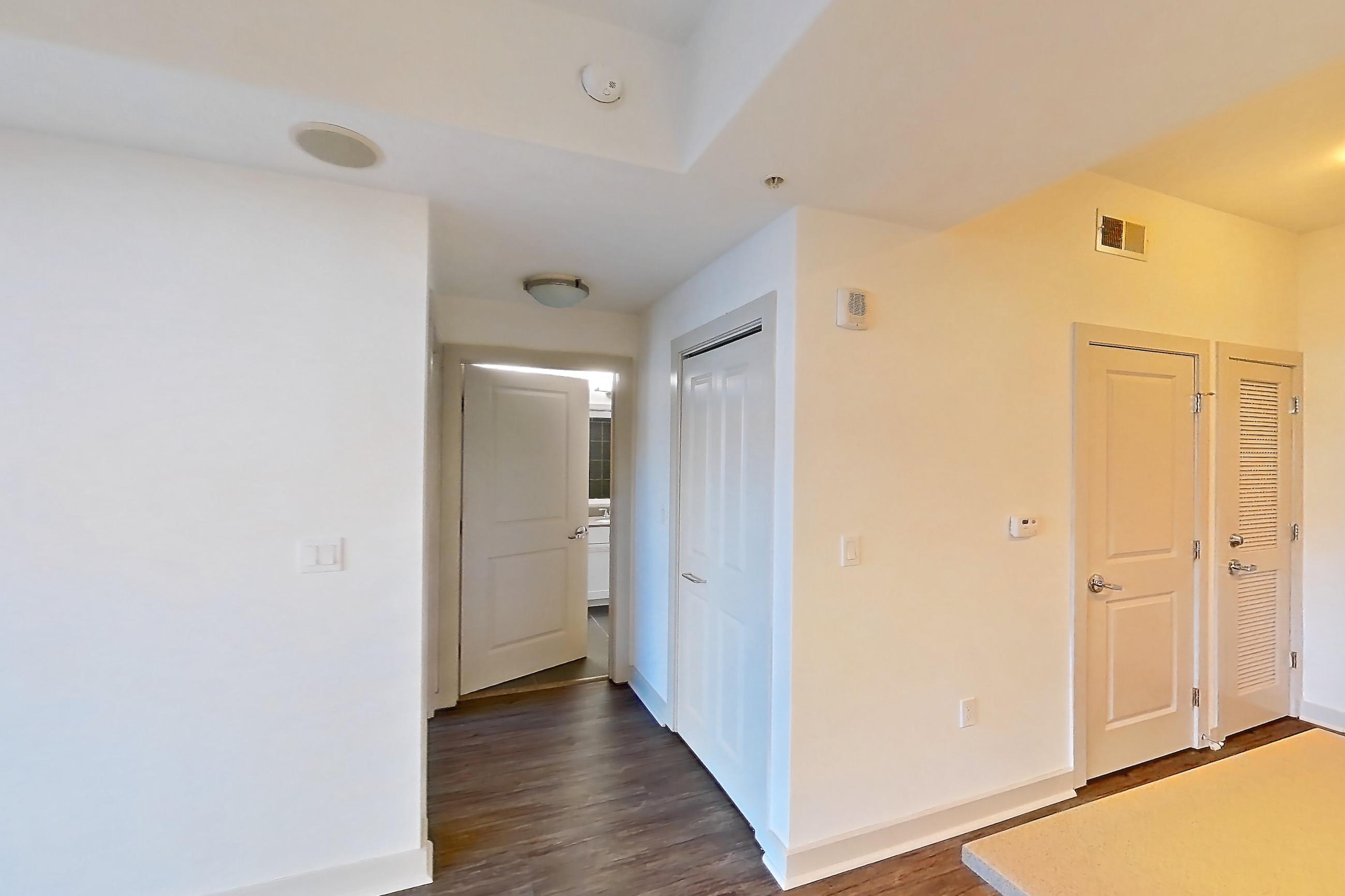 Dining room with dark wood-finish flooring and light stone countertops, Apartment 0203 at Cyan on Peachtree