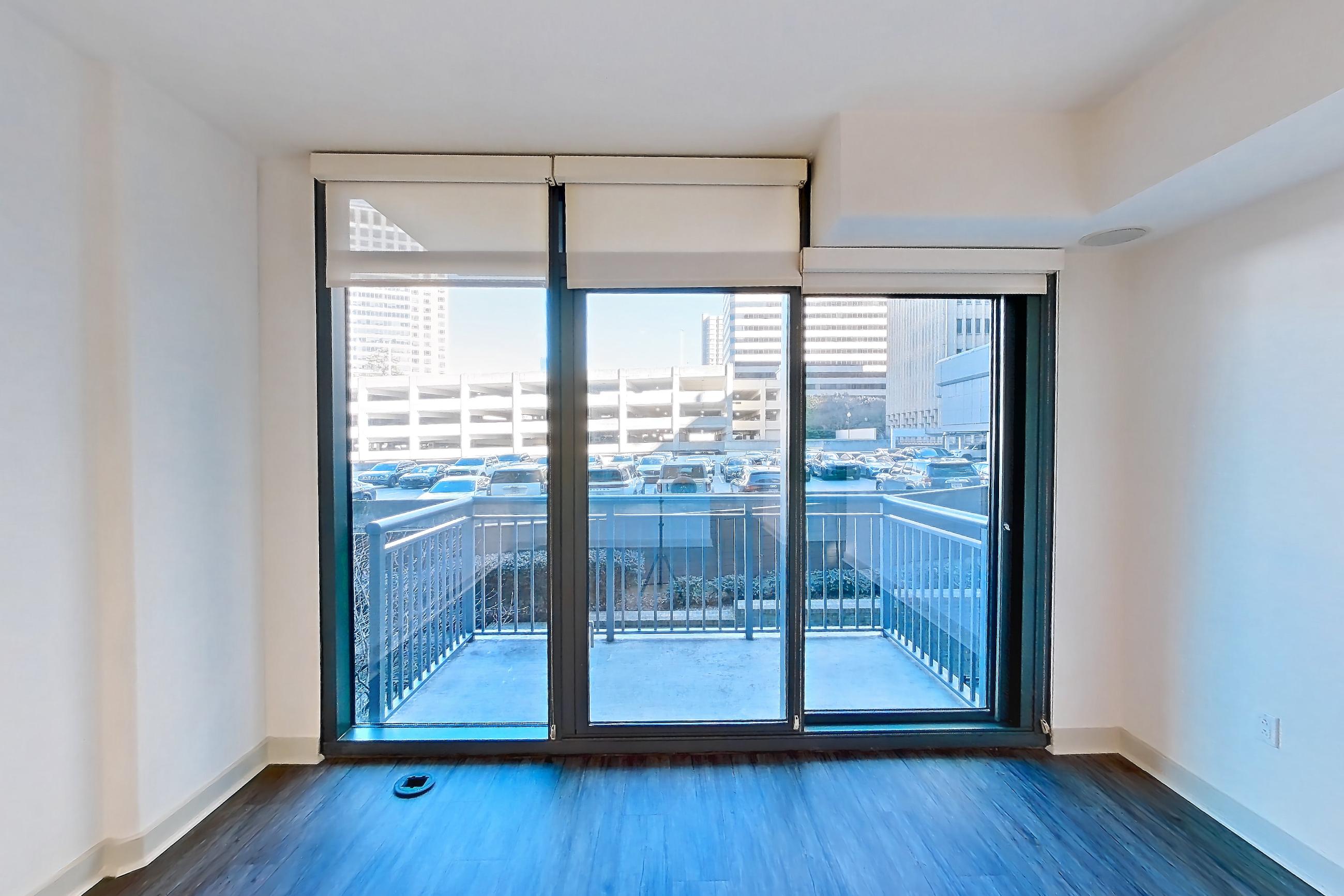 Living room with dark wood-finish flooring, Apartment 0203 at Cyan on Peachtree