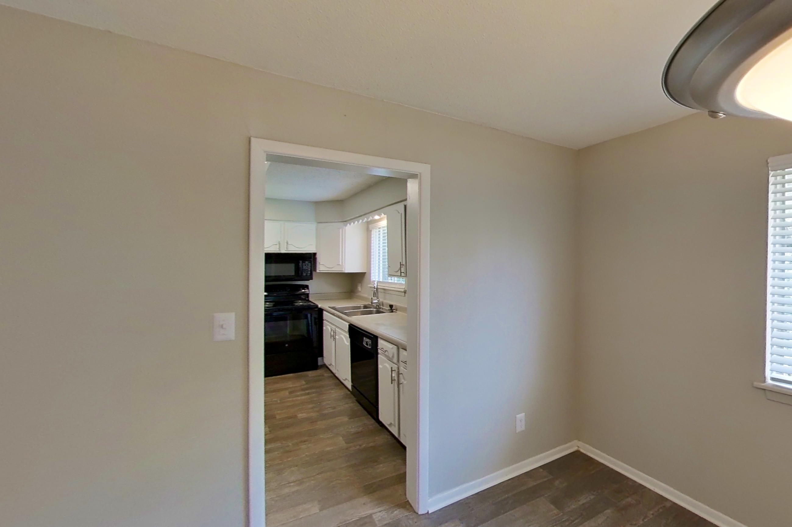 Dining room with black appliances, dark wood-finish flooring, dishwasher, electric range, light countertops, and oven/range, Apartment 9606D at The Life at Legacy Fountains