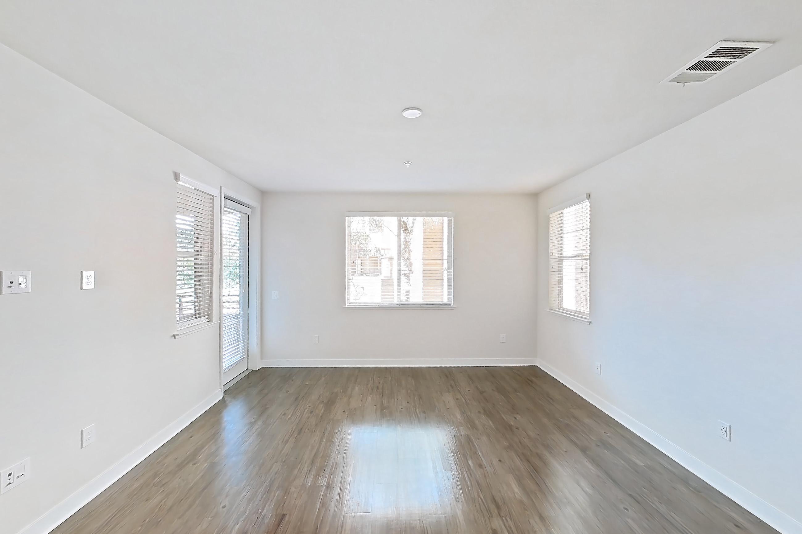 Living room with dark wood-finish flooring, Apartment 1218 at The Verge Apartments