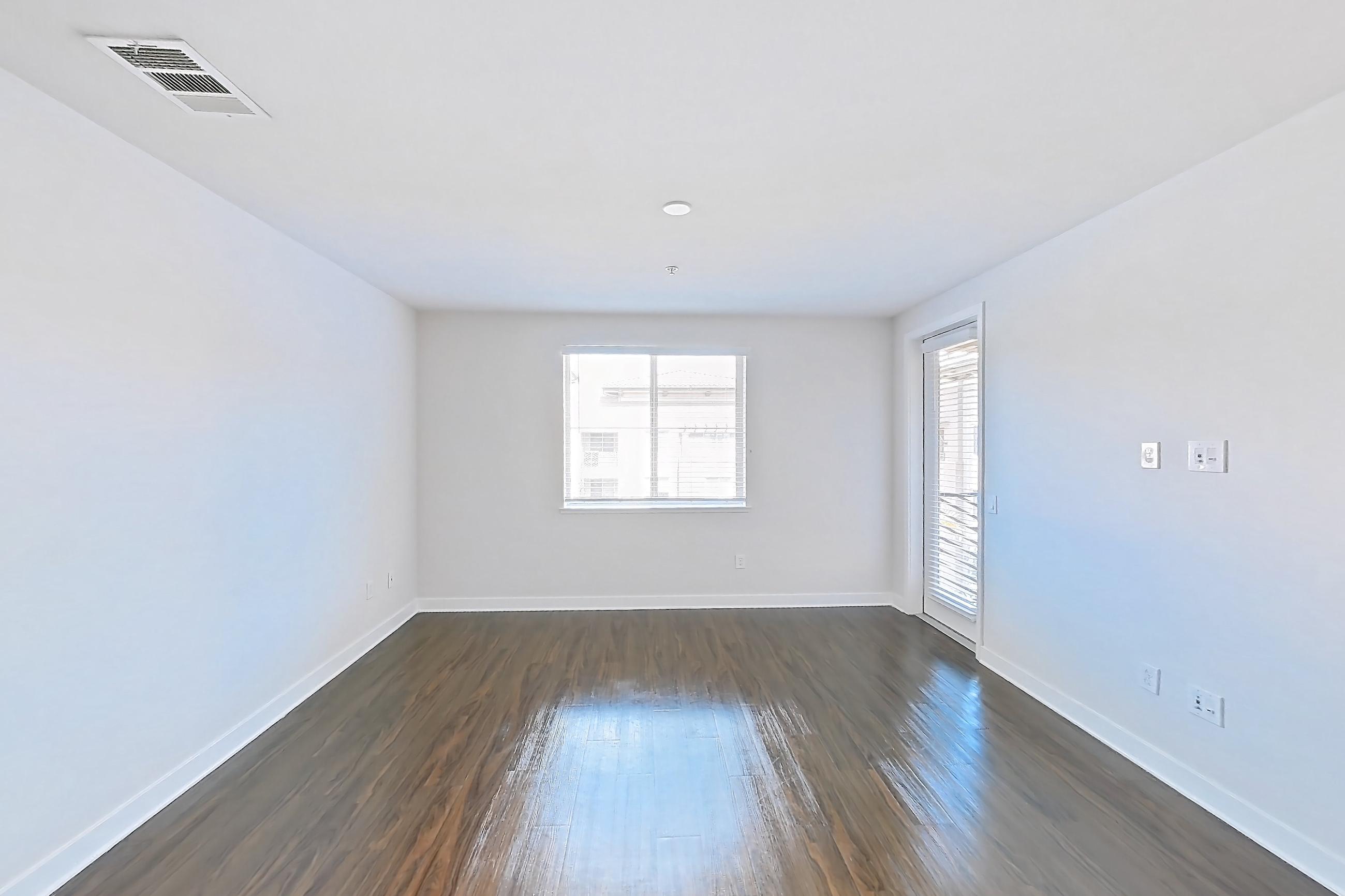 Living room with dark wood-finish flooring, Apartment 1443 at The Verge Apartments