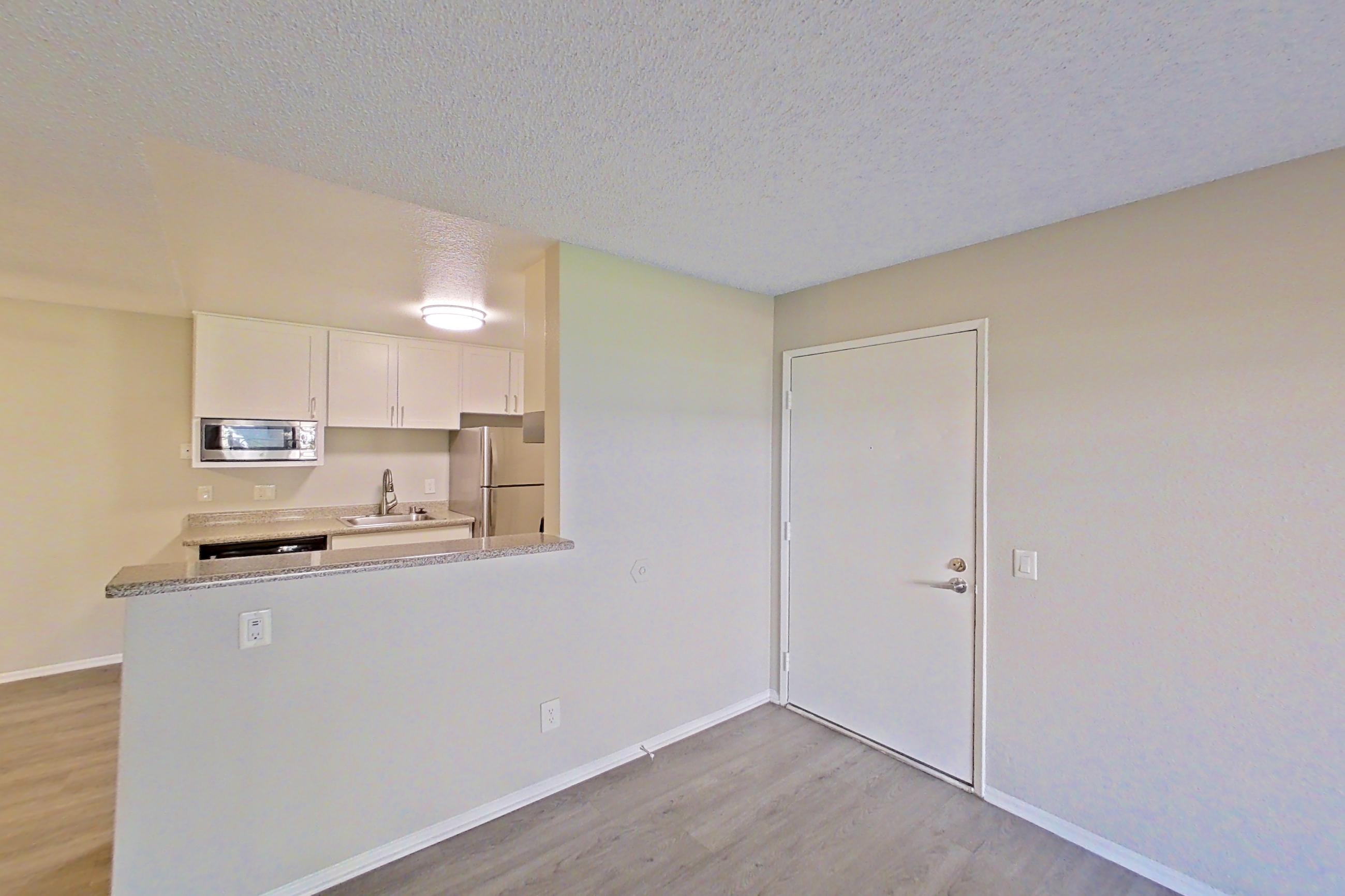Living room with refrigerator, Apartment 04-04 at Avana Rancho Cucamonga