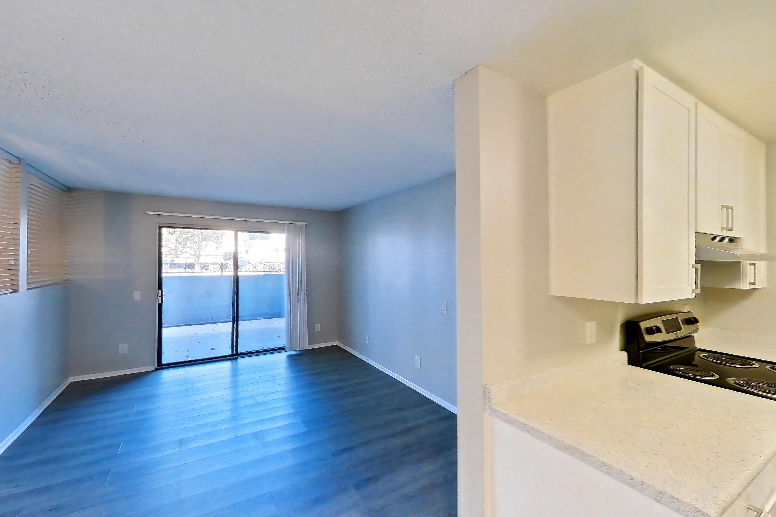 Dining room with electric range, light countertops, light wood-finish flooring, oven/range, and stainless steel appliances, Apartment 07-08 at Avana Rancho Cucamonga