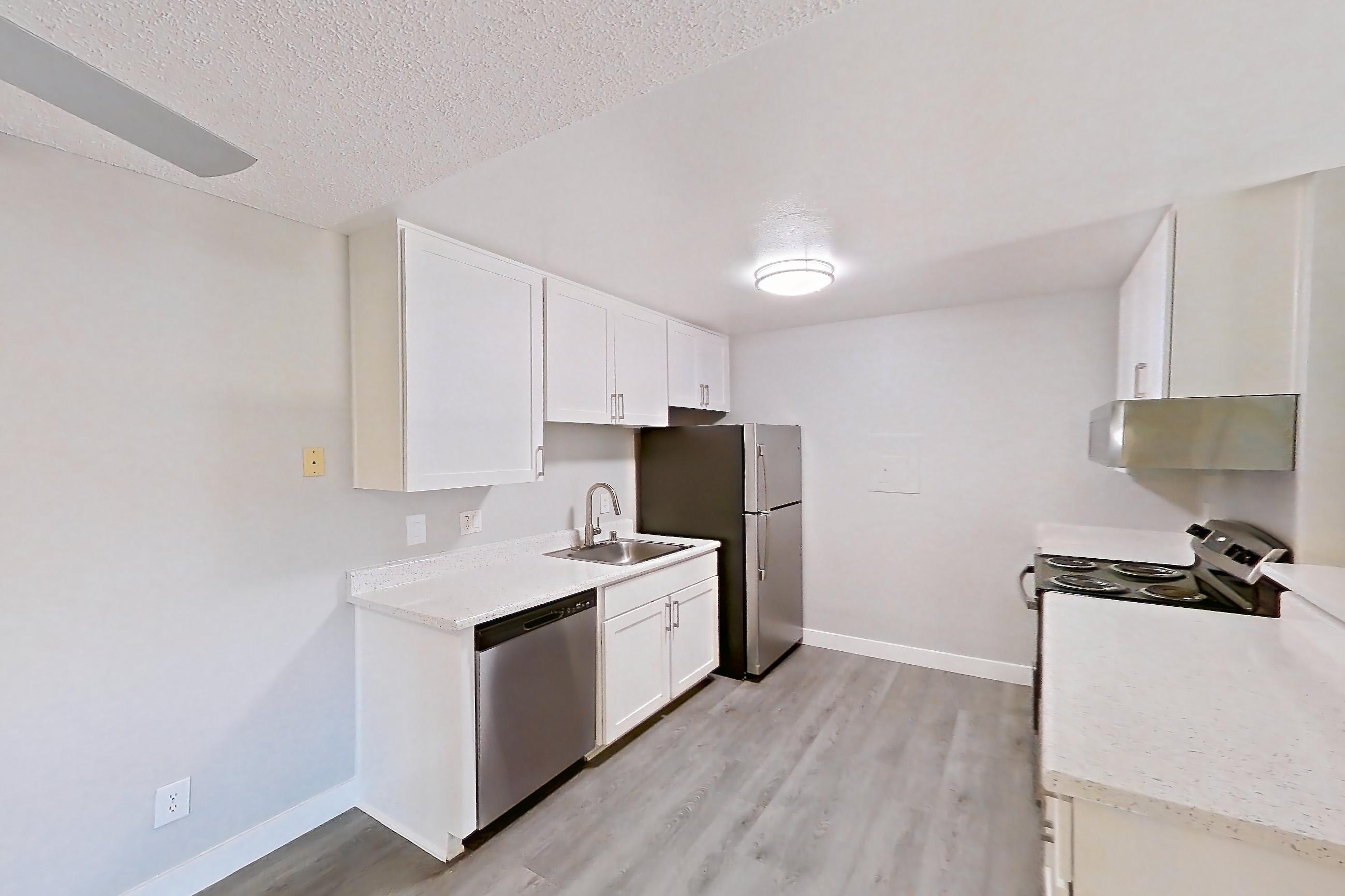 Dining room with black appliances, dishwasher, electric range, light carpet, light countertops, light stone countertops, light wood-finish flooring, oven/range, refrigerator, and stainless steel appliances, Apartment 16-01 at Avana Rancho Cucamonga