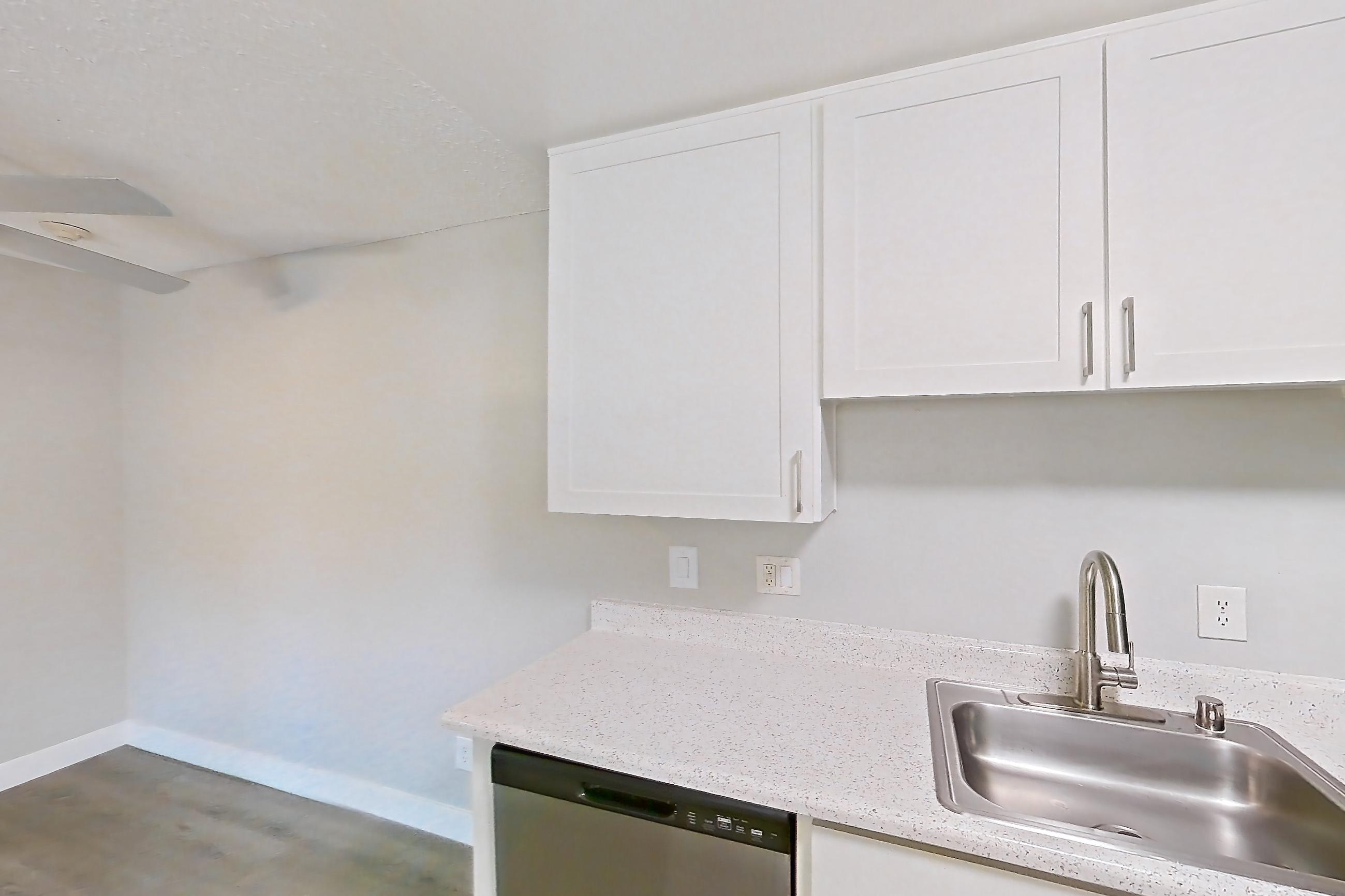 Kitchen with dishwasher, electric range, light countertops, light stone countertops, light wood-finish flooring, oven/range, and stainless steel appliances, Apartment 16-01 at Avana Rancho Cucamonga