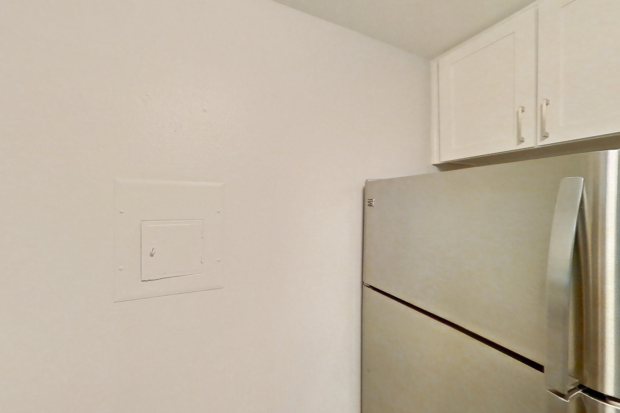 Kitchen with electric range, light countertops, light stone countertops, light wood-finish flooring, oven/range, refrigerator, and stainless steel appliances, Apartment 19-02 at Avana Rancho Cucamonga