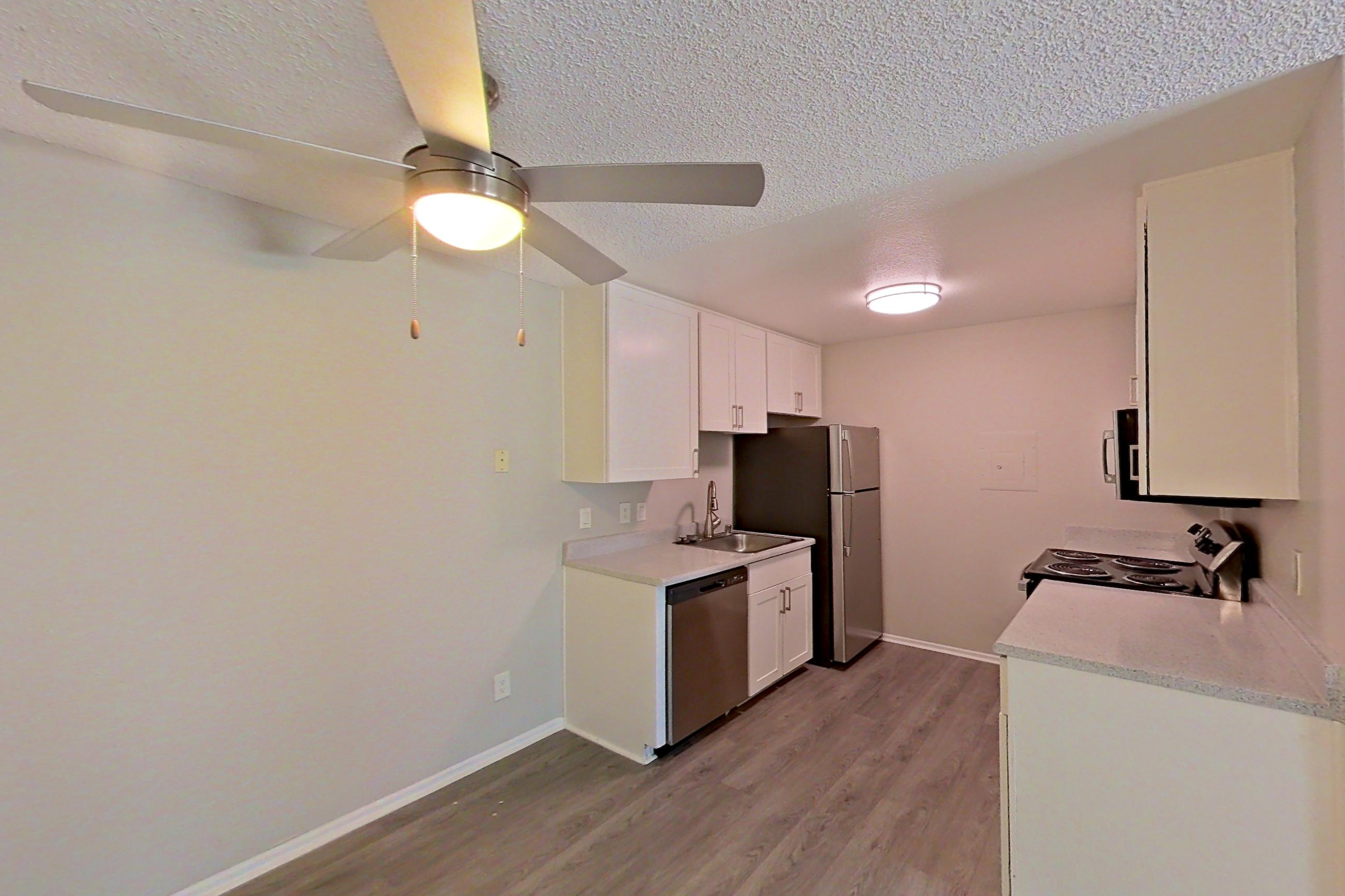 Dining area with dishwasher, light countertops, refrigerator, and stainless steel appliances, Apartment 02-02 at Avana Rancho Cucamonga