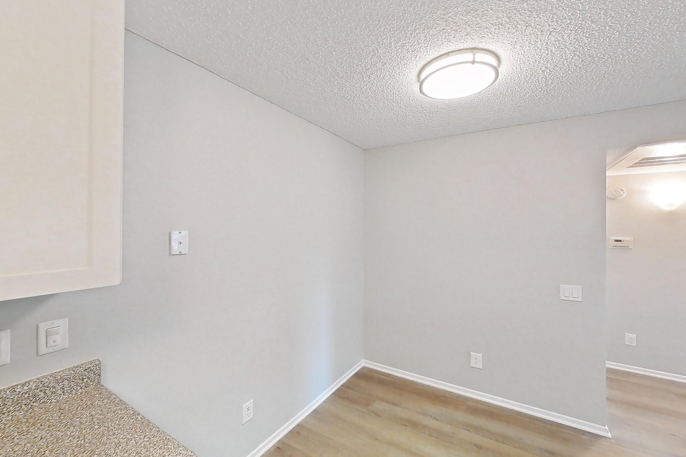 Kitchen with dishwasher, light countertops, light wood-finish flooring, refrigerator, and stainless steel appliances, Apartment 13-08 at Avana Rancho Cucamonga