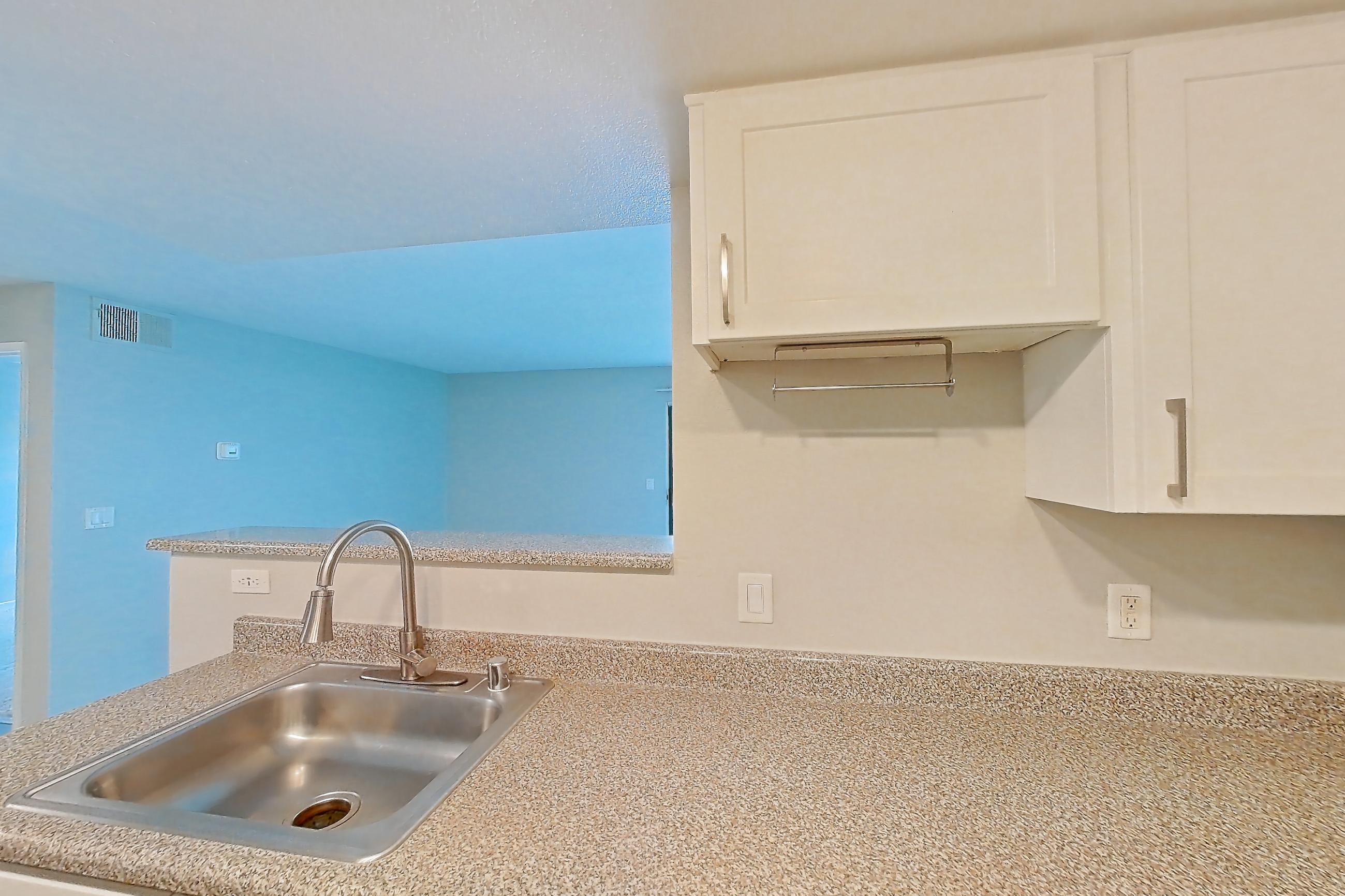 Kitchen with dishwasher, electric range, light countertops, oven/range, and stainless steel appliances, Apartment 06 at Avana Rancho Cucamonga
