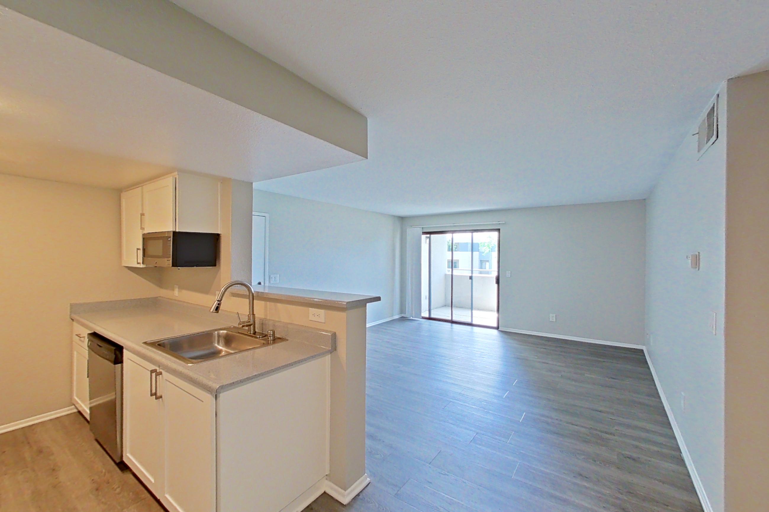 Dining area with dishwasher, electric range, light countertops, light wood-finish flooring, oven/range, refrigerator, and stainless steel appliances, Apartment 20 at Avana Rancho Cucamonga