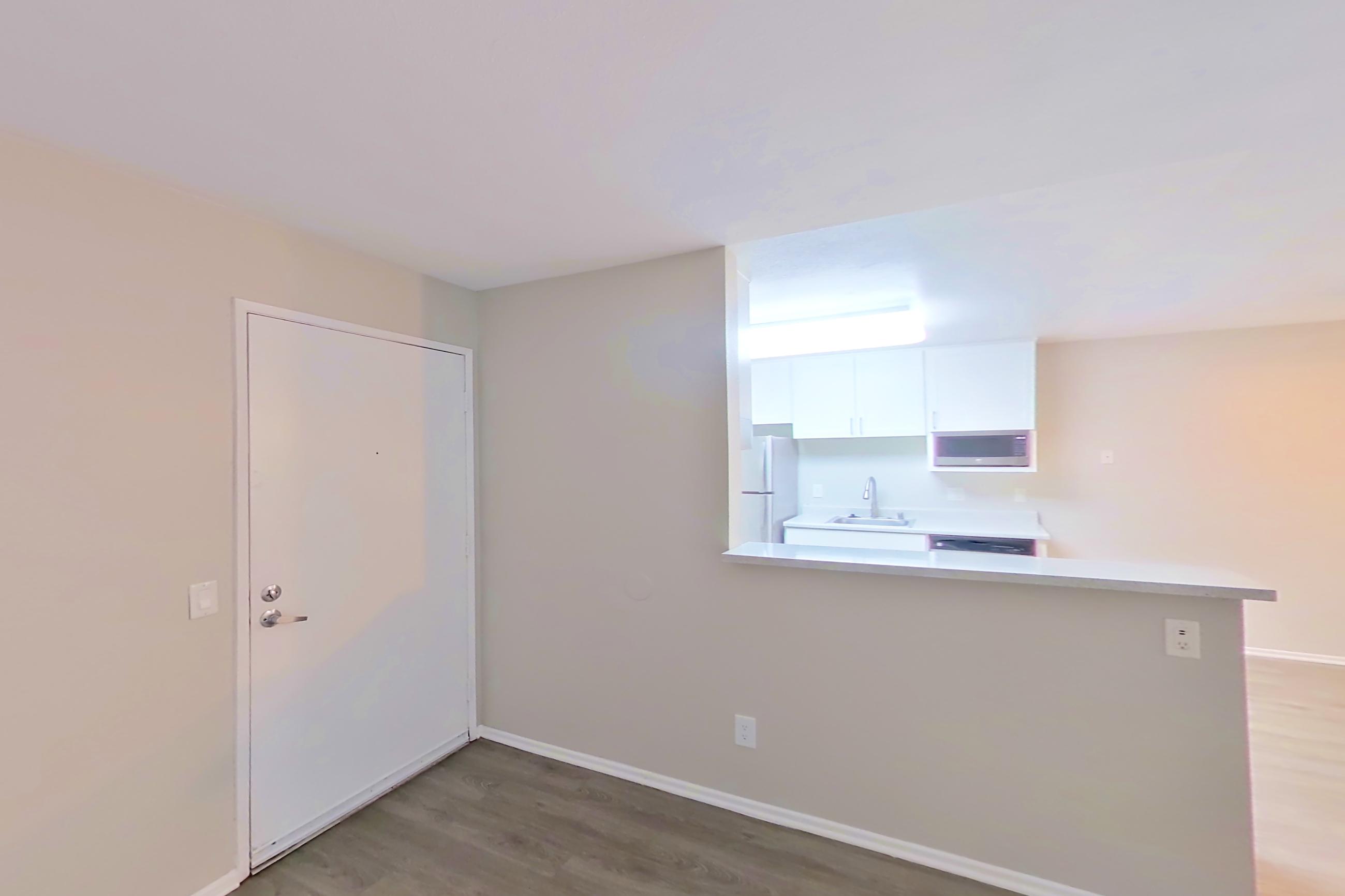 Living room with light wood-finish flooring, Apartment 16-14 at Avana Rancho Cucamonga