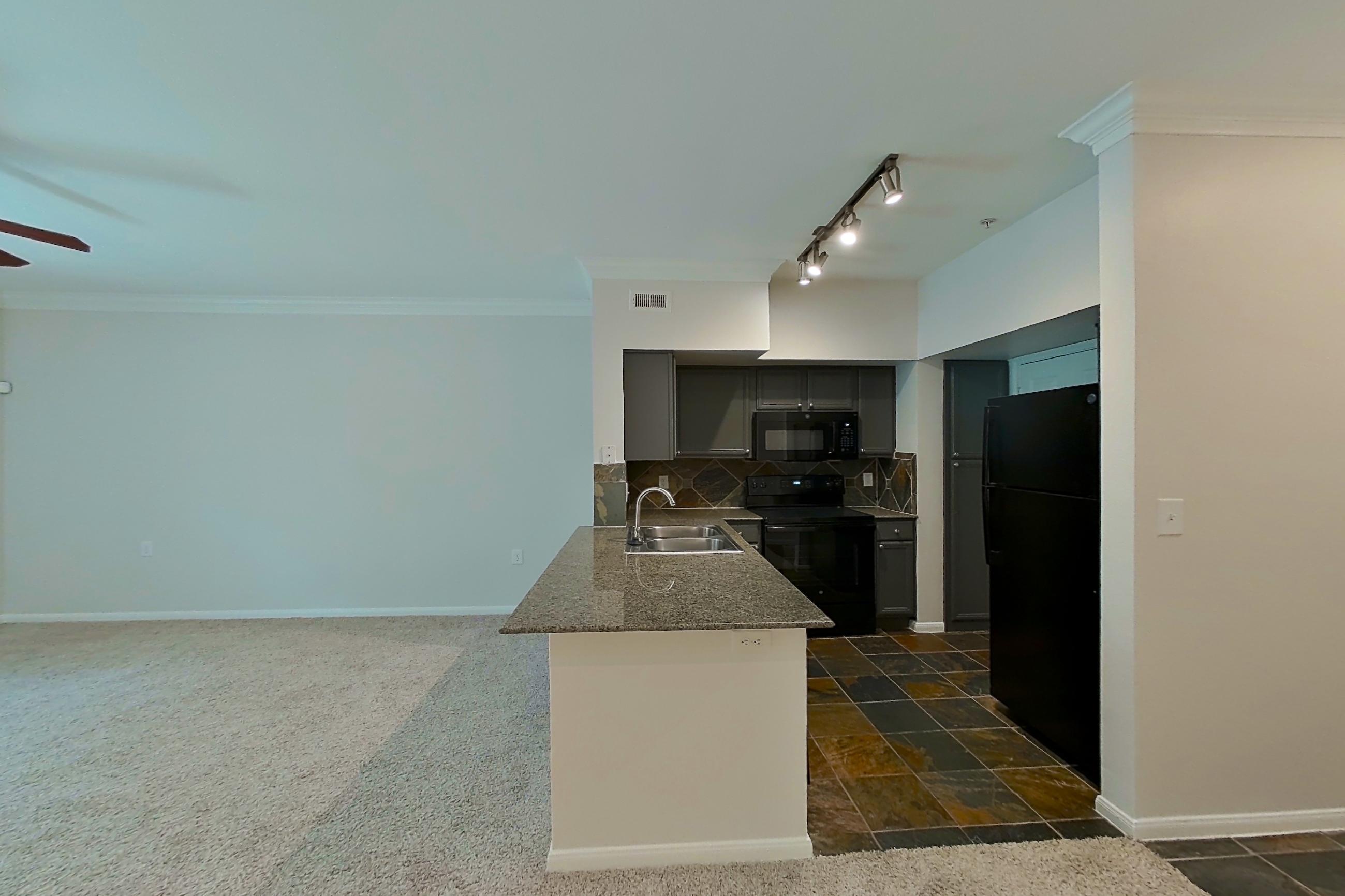 Dining room with black appliances, dark carpet, dark stone-finish flooring, electric range, and oven/range, Apartment 0234 at Portico Kirby