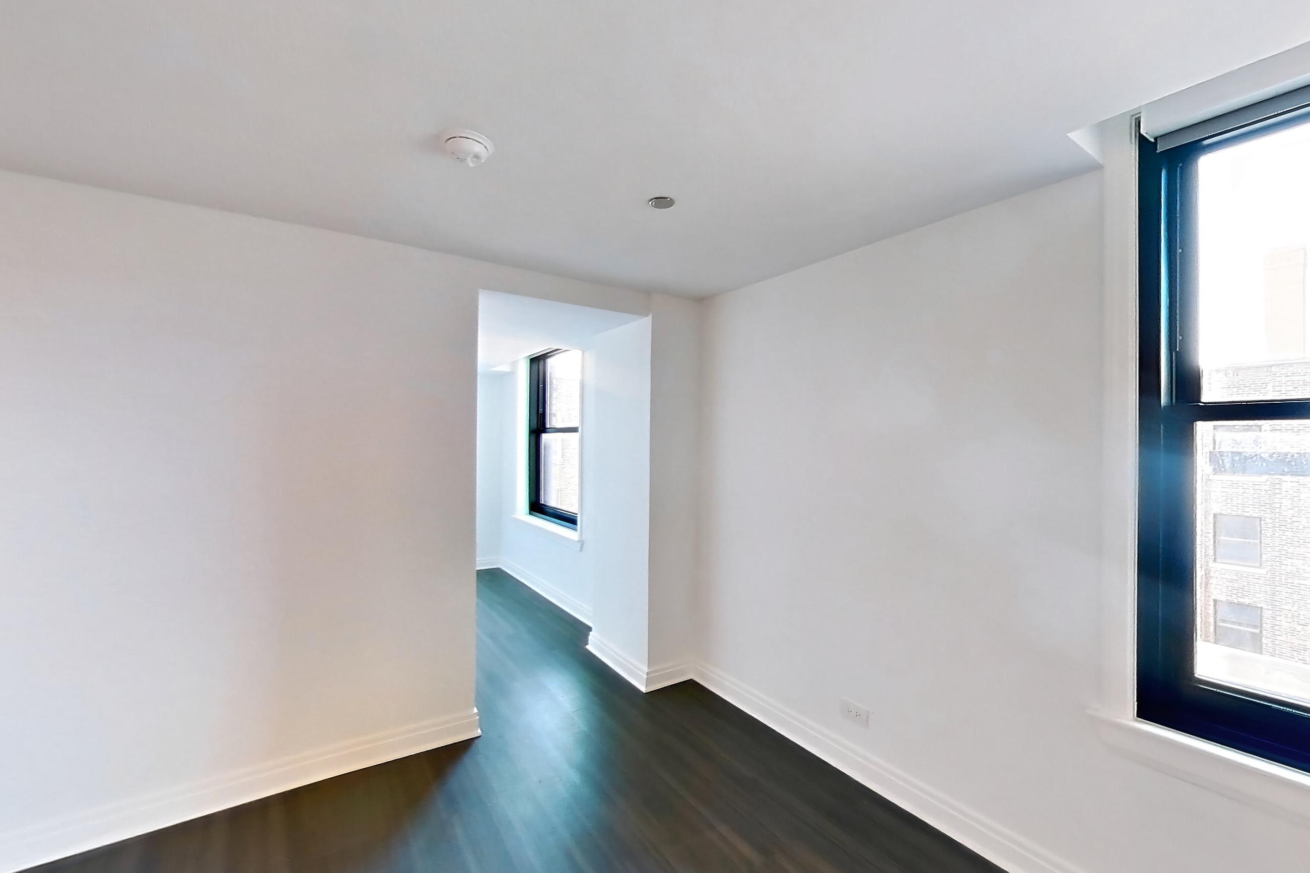 Kitchen with dark wood-finish flooring, Apartment 309 at The Belden-Stratford