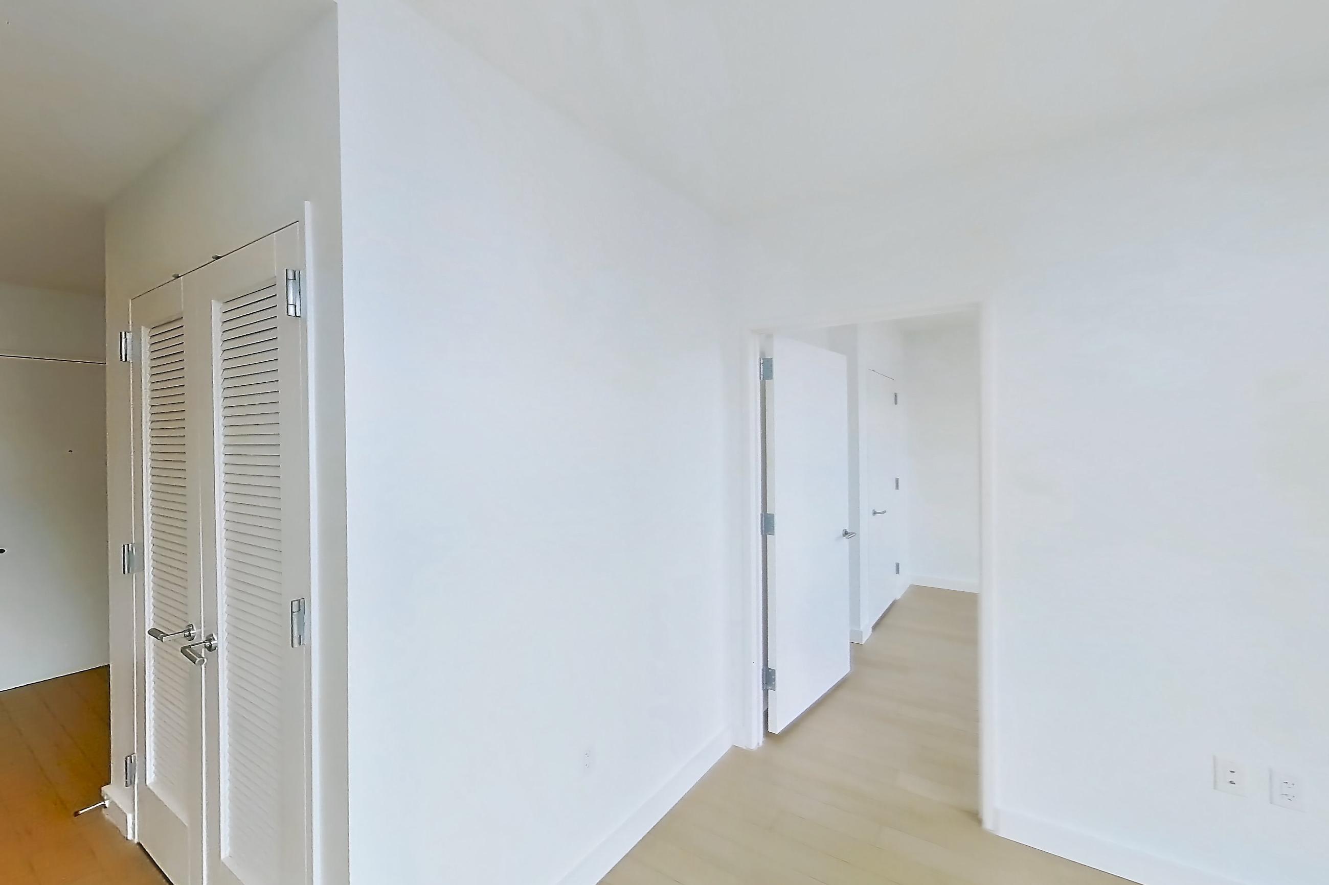 Living room with city view, light wood-finish flooring, and water view, Apartment 0-PHH at One Blue Slip