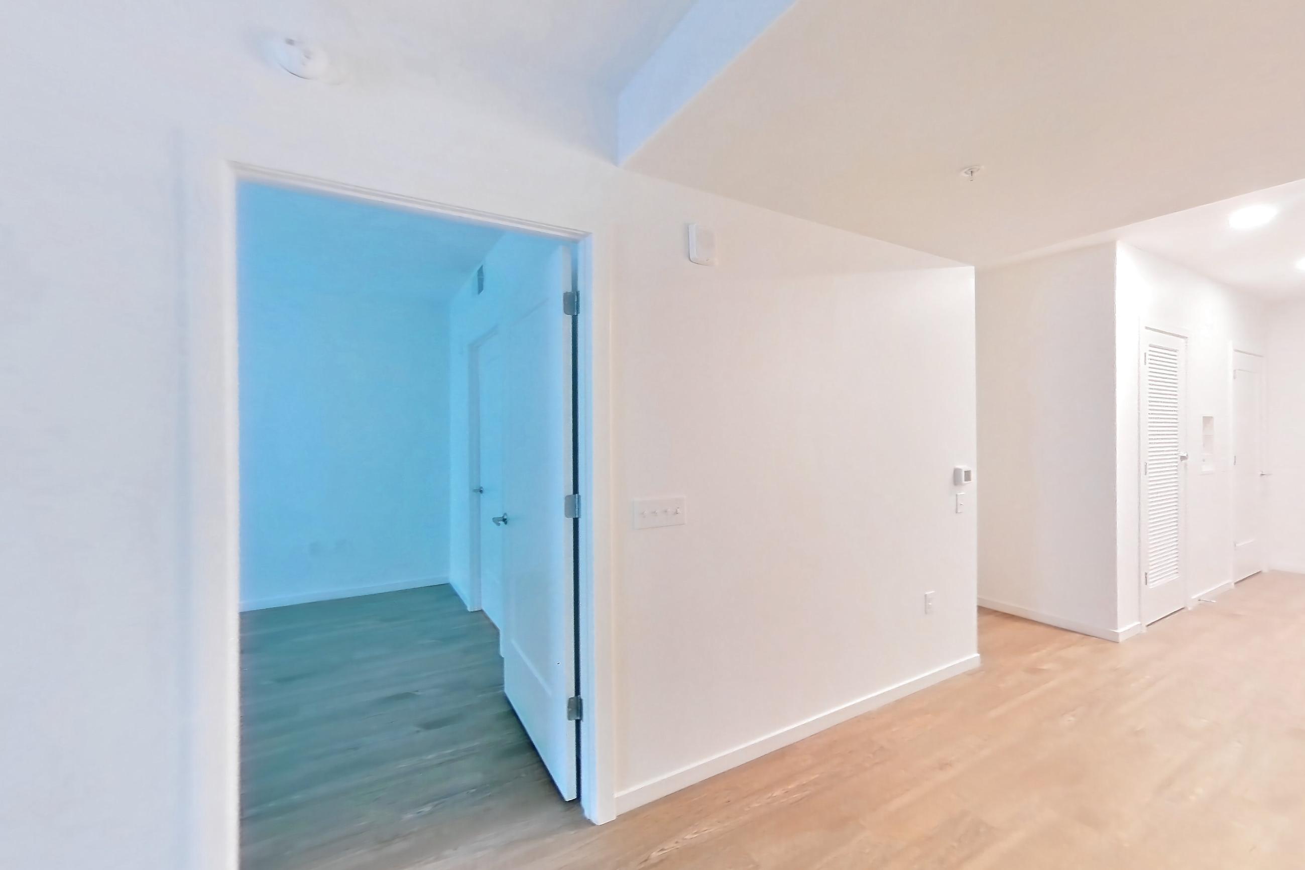 Living room with light wood-finish flooring, Apartment 1806 at Cortland Rosslyn