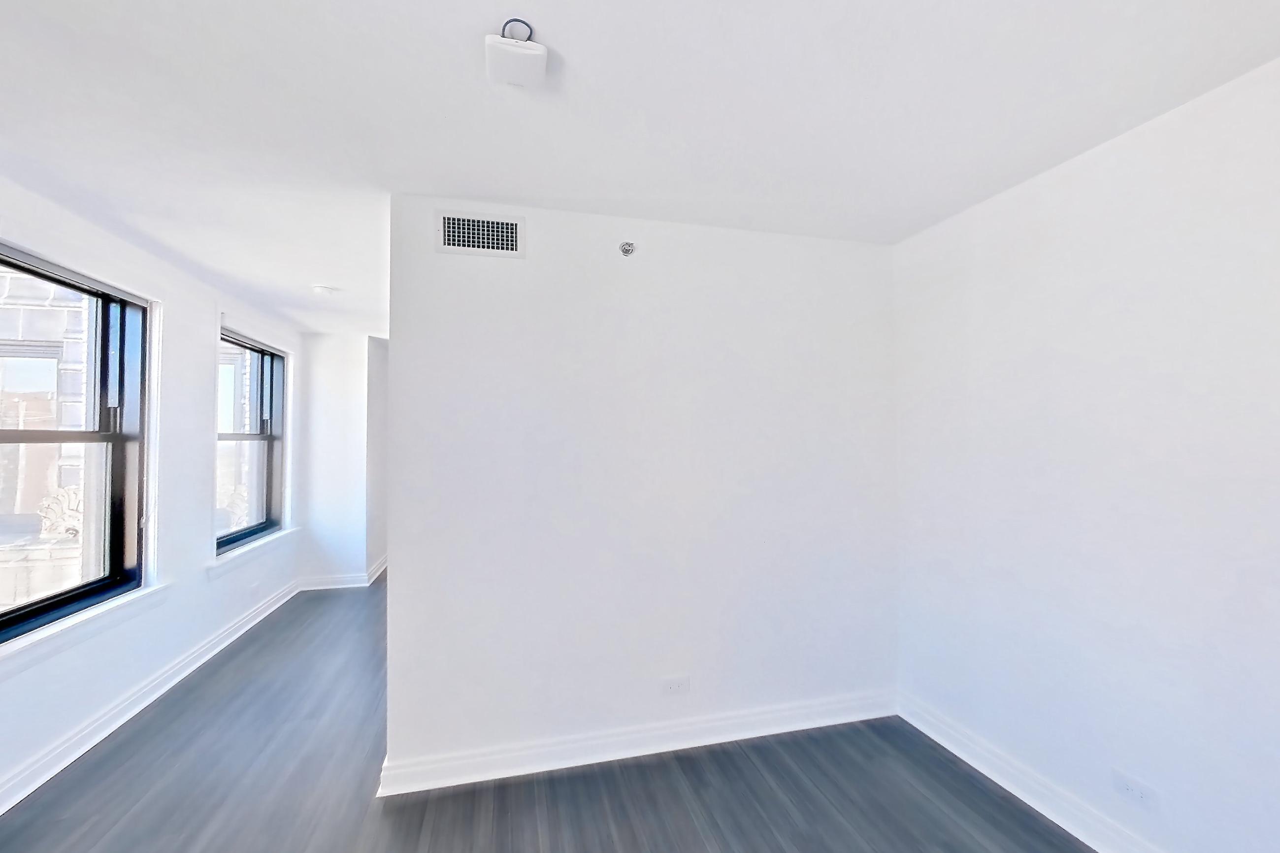 Kitchen with dark wood-finish flooring, Apartment 1510 at The Belden-Stratford