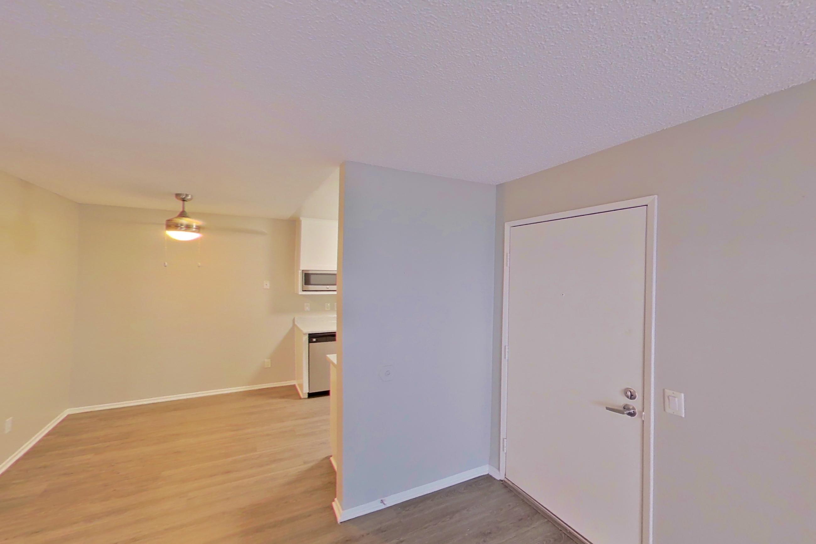 Living room with dishwasher and stainless steel appliances, Apartment 17-02 at Avana Rancho Cucamonga