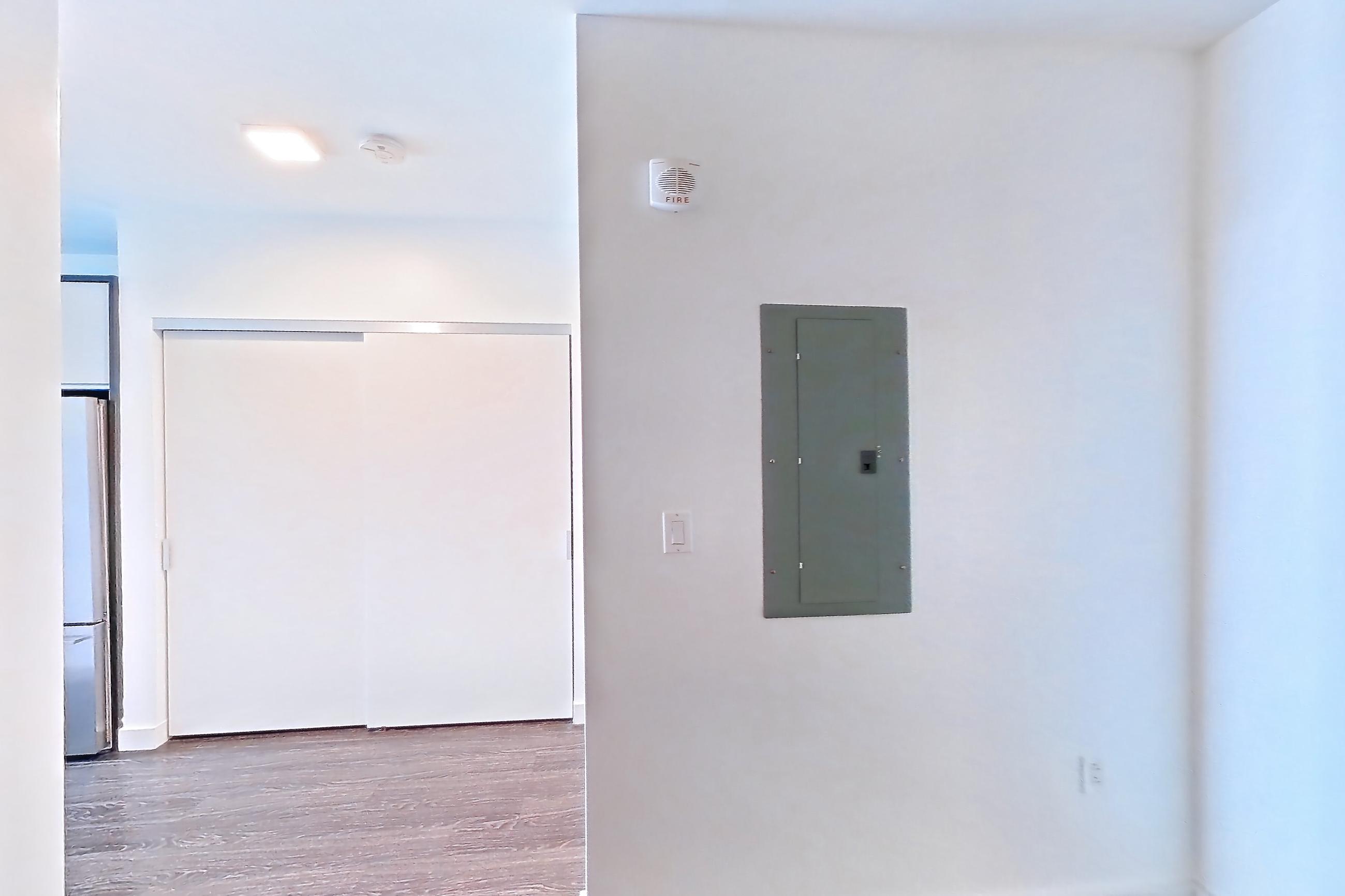Living space with dark wood-finish flooring, Apartment 1004 at The Eddy