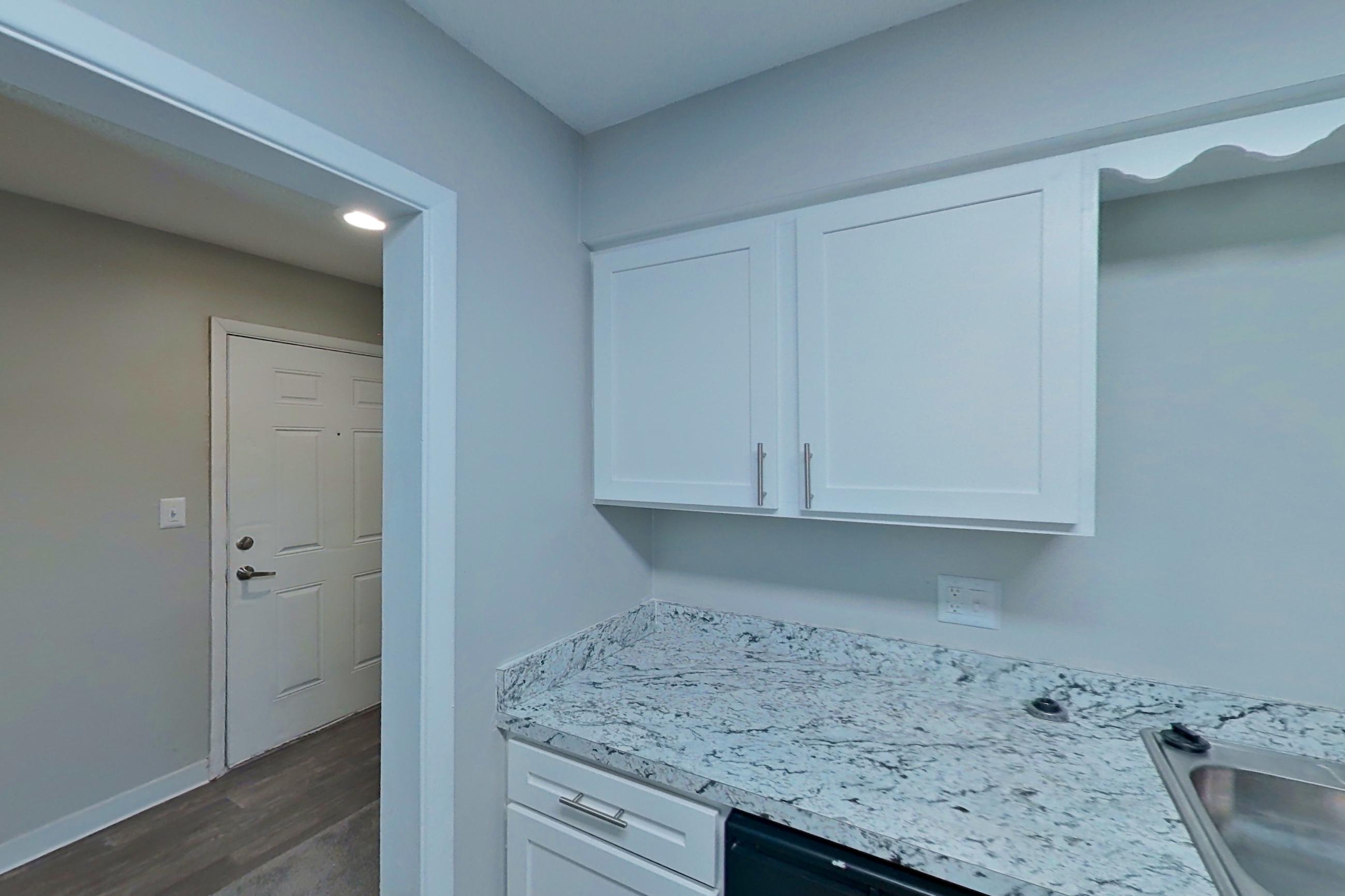 Kitchen with black appliances, dishwasher, electric range, light stone countertops, light wood-finish flooring, oven/range, and refrigerator, Apartment 9600A at The Life at Legacy Fountains