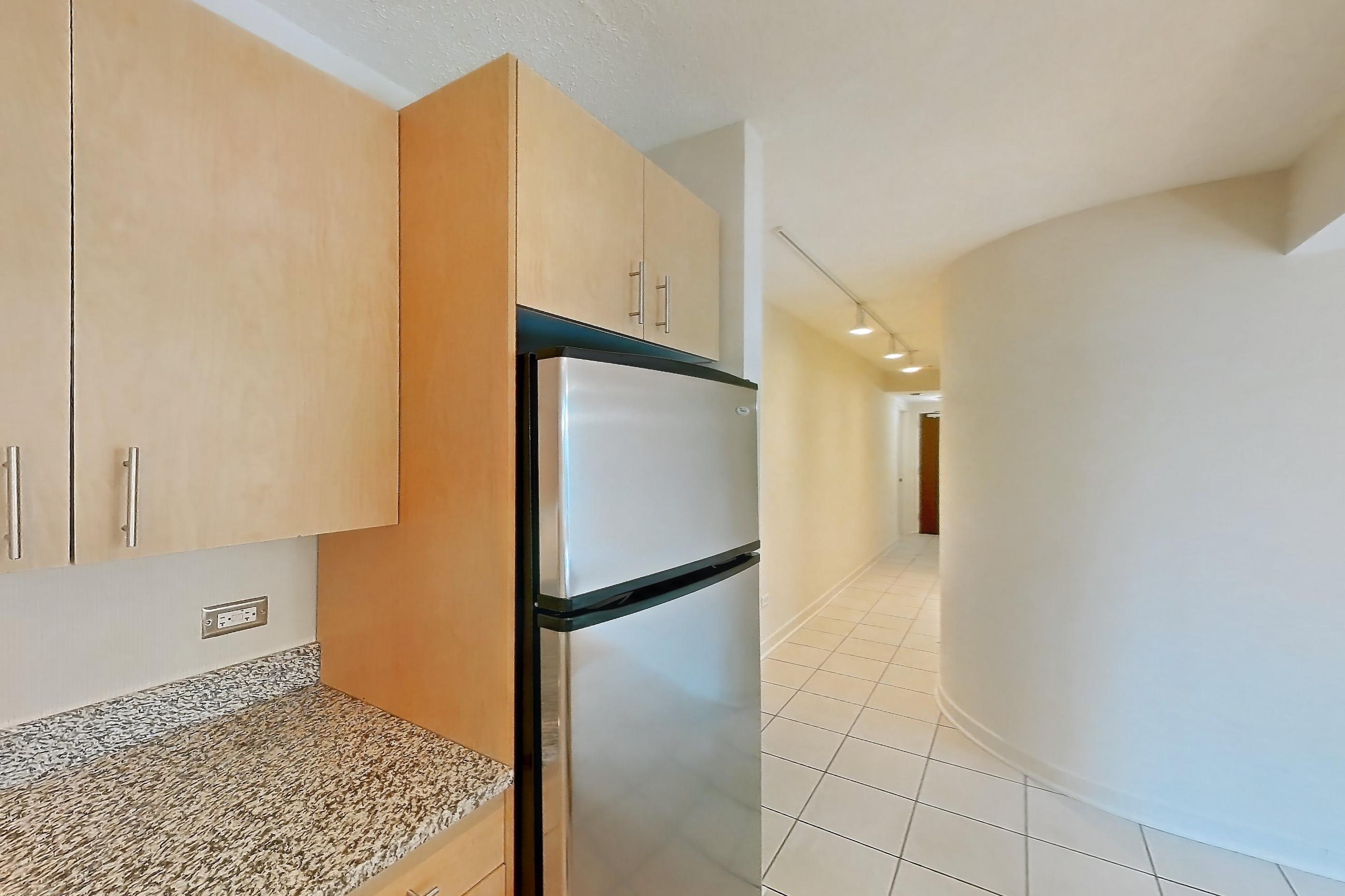 Kitchen with dishwasher, electric range, light stone countertops, light tile flooring, microwave, oven/range, refrigerator, stainless steel appliances, and white appliances, Apartment 00-0305 at Sky55