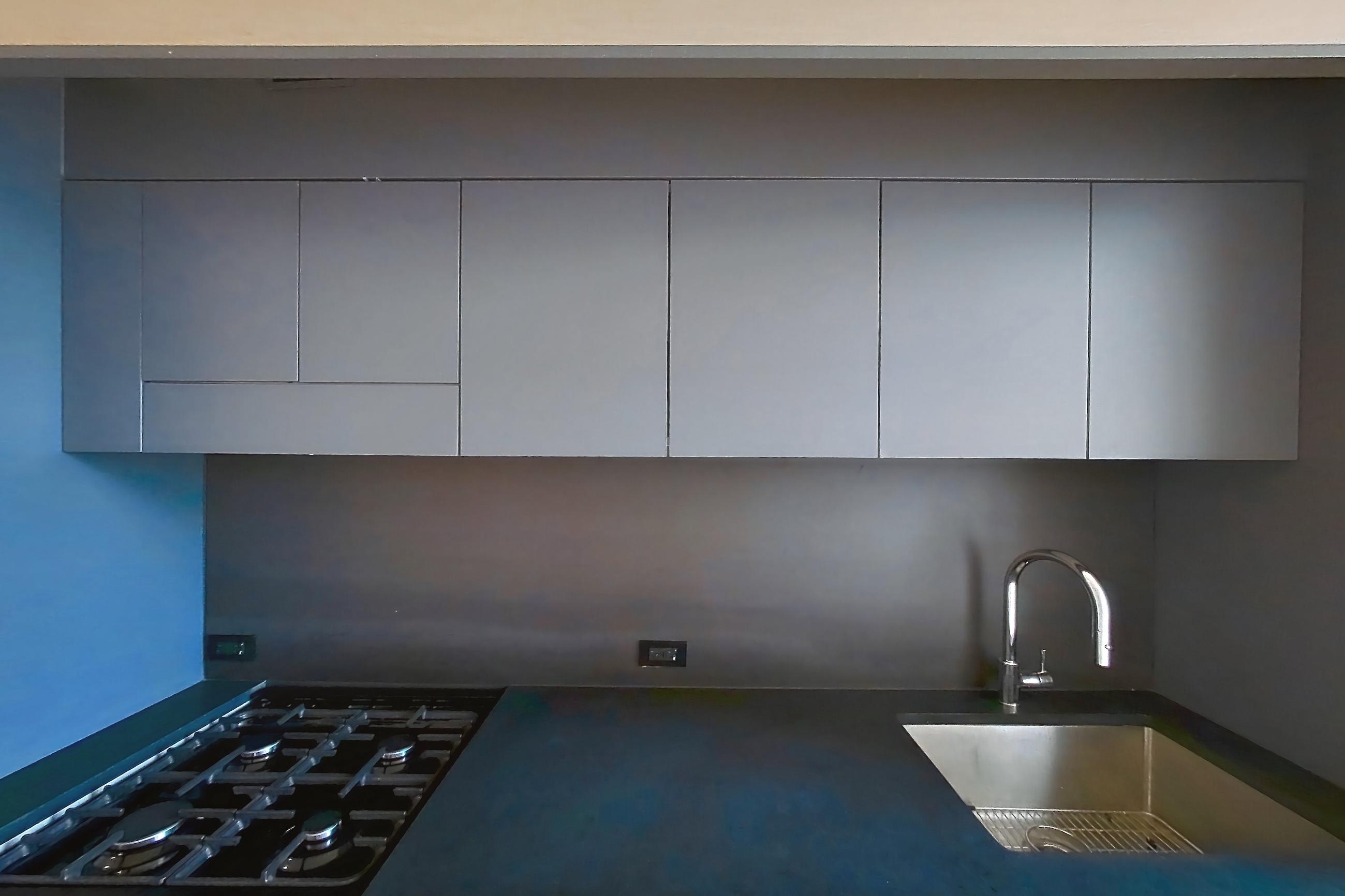 Kitchen with gas range, light wood-finish flooring, oven/range, and stainless steel appliances, Apartment 1-0101 at Eagle + West