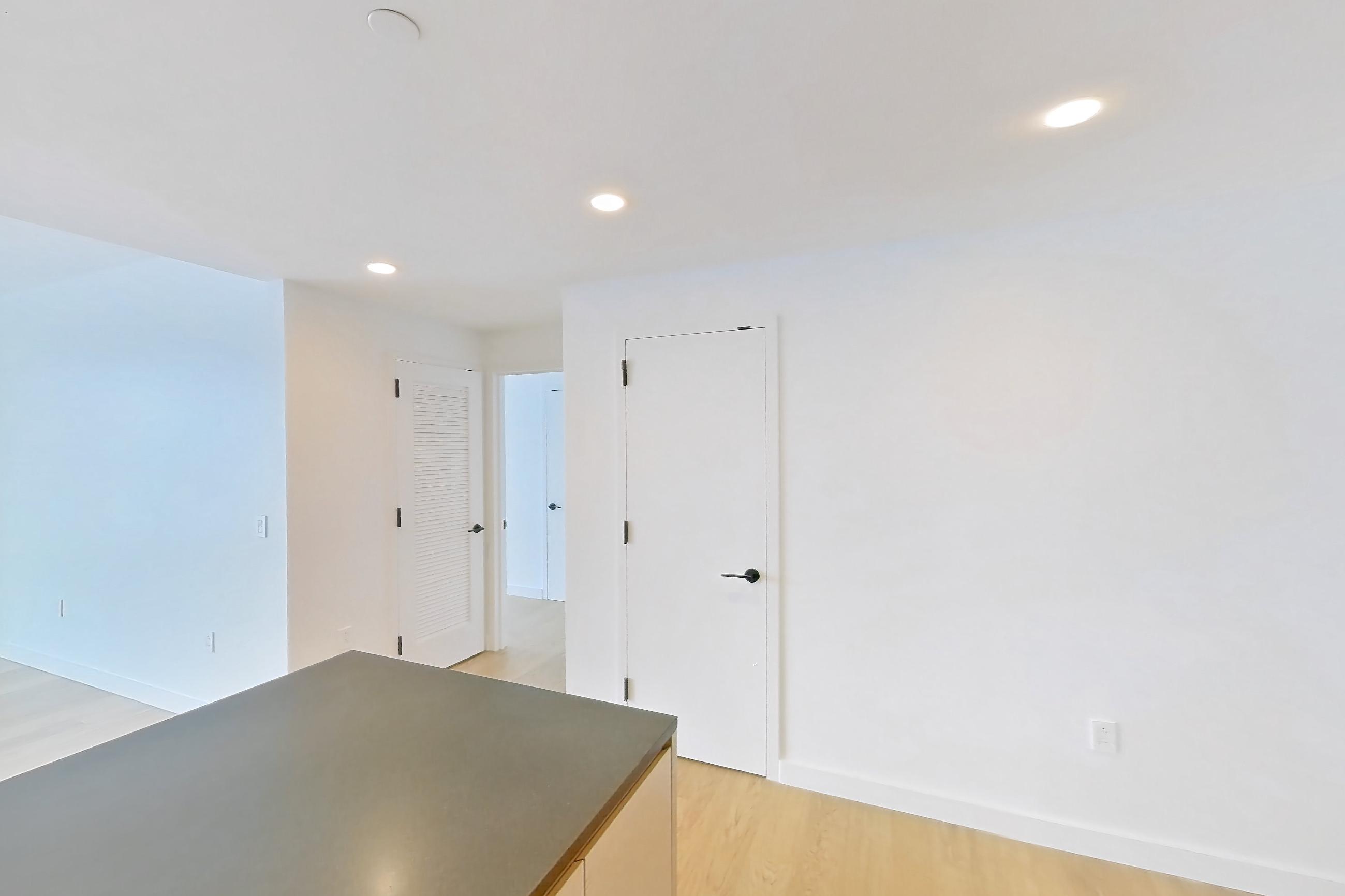 Kitchen with gas range, light wood-finish flooring, oven/range, and stainless steel appliances, Apartment 1-3107 at Eagle + West