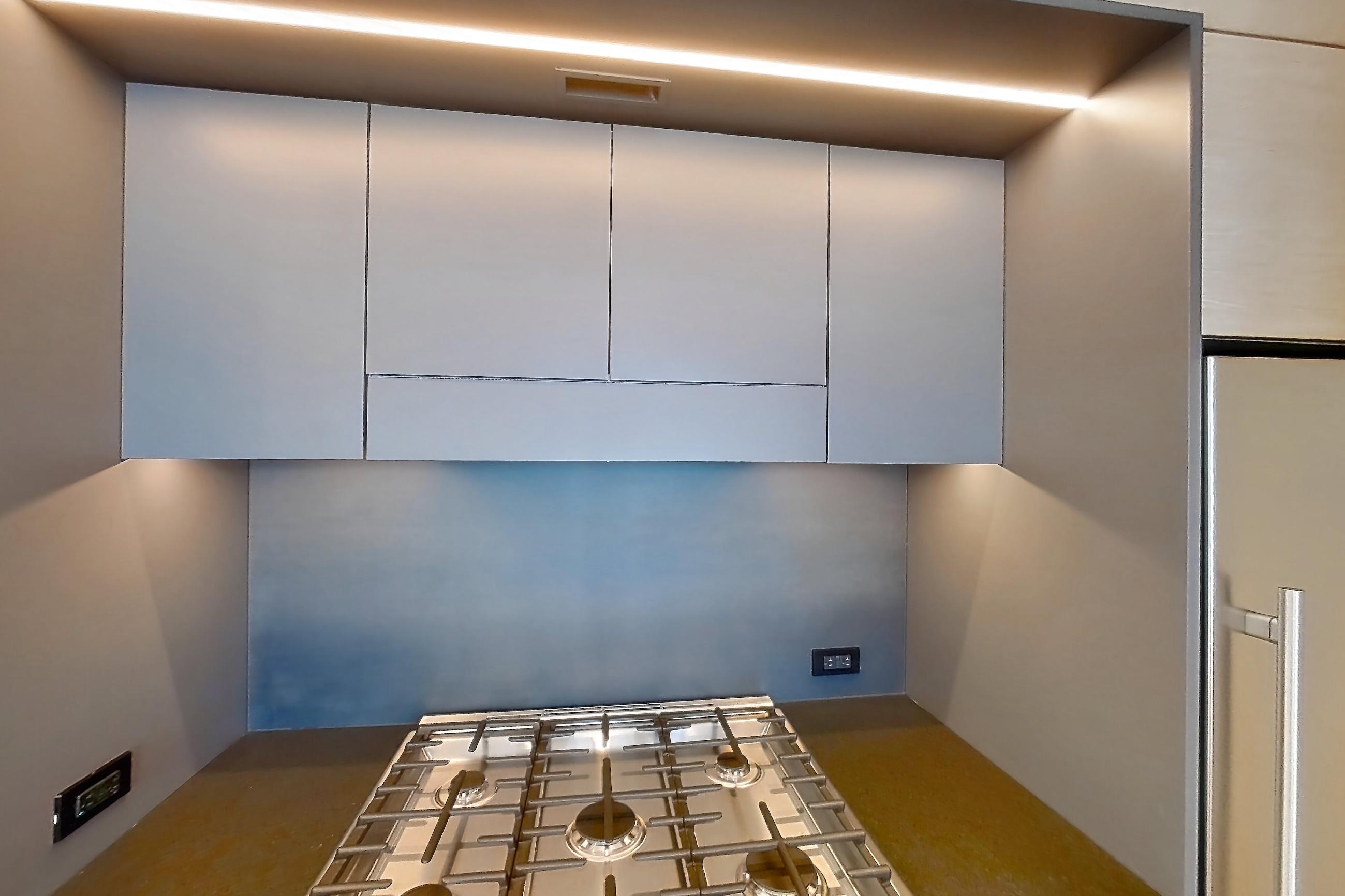 Kitchen with gas range, light wood-finish flooring, oven/range, and stainless steel appliances, Apartment 1-3107 at Eagle + West