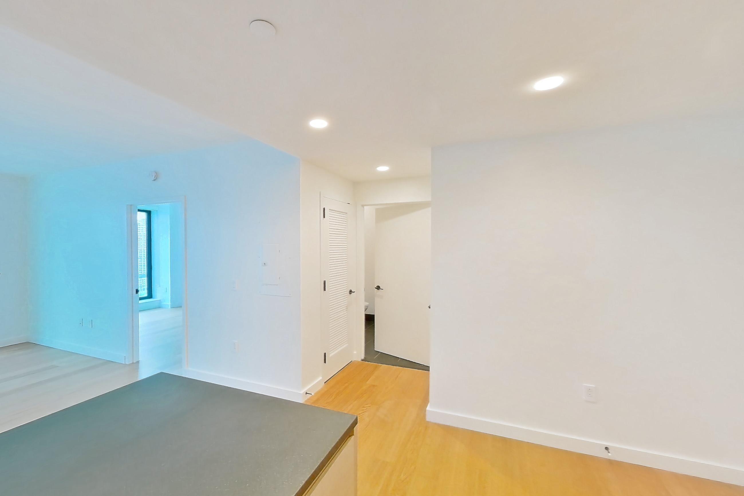 Kitchen with gas range, light wood-finish flooring, oven/range, and stainless steel appliances, Apartment 1-2505 at Eagle + West
