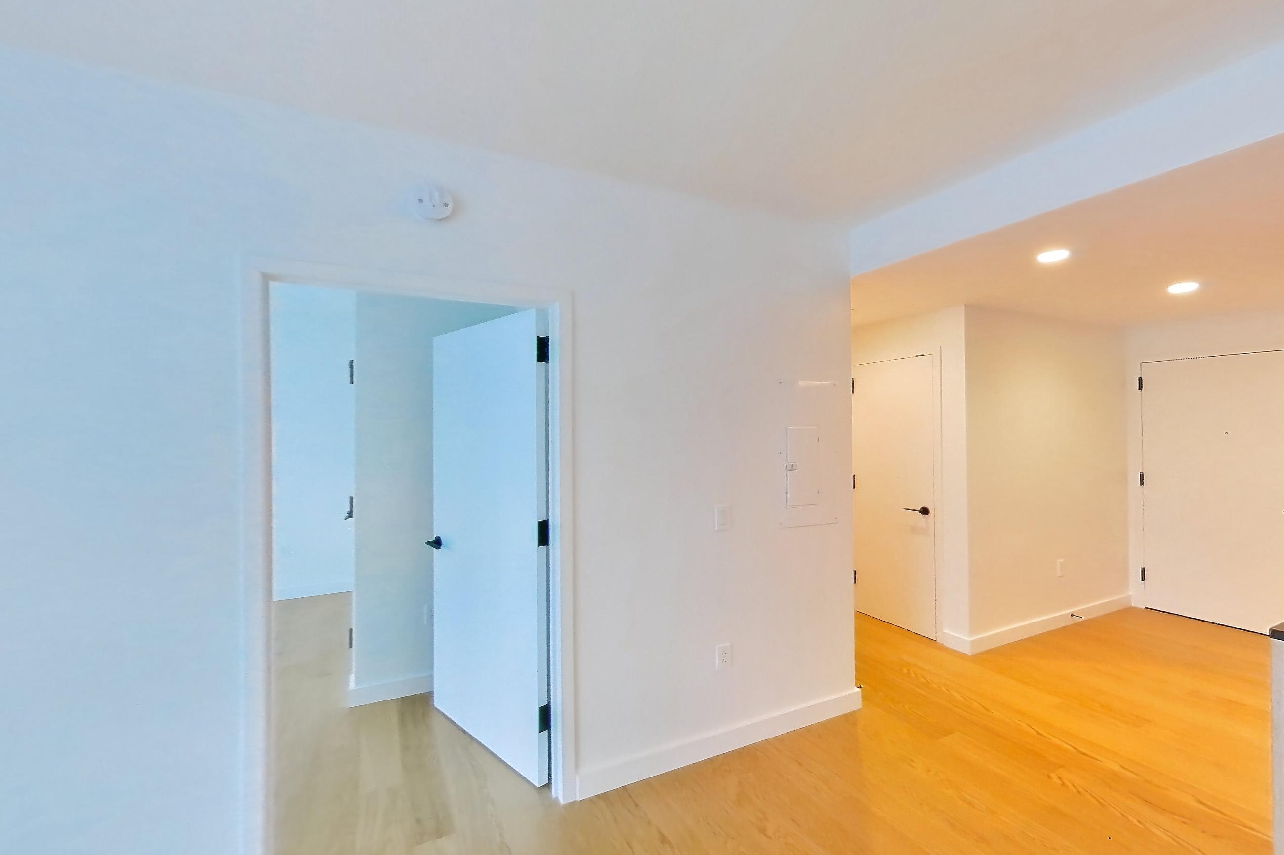 Living room with light wood-finish flooring, Apartment 1-2505 at Eagle + West