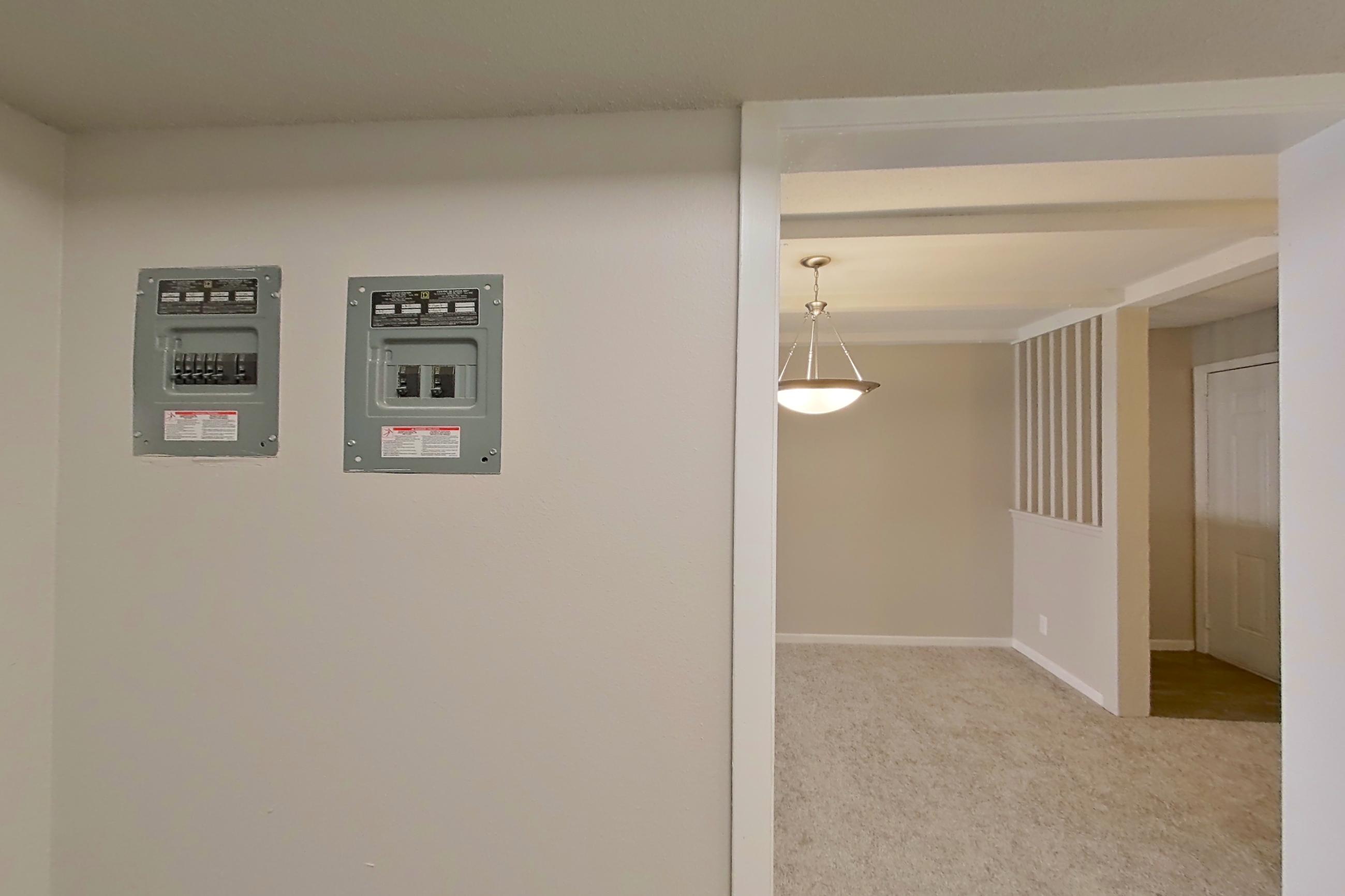 Kitchen with black appliances, dishwasher, electric range, light countertops, light wood-finish flooring, oven/range, and refrigerator, Apartment 1524C at The Life at Legacy Fountains