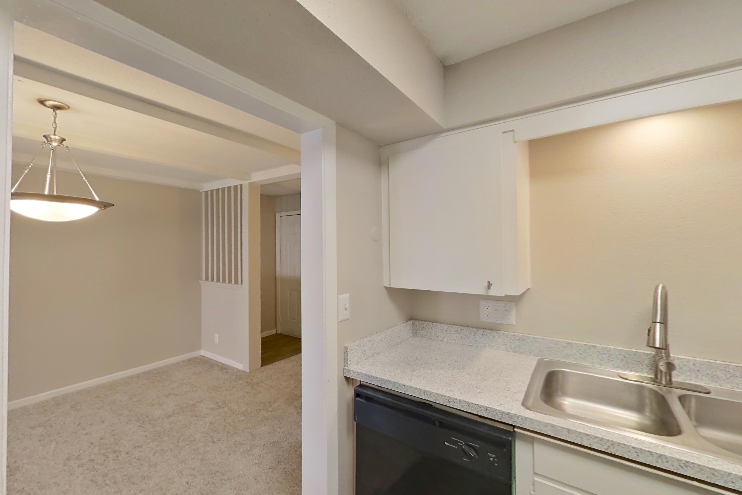 Kitchen with black appliances, dishwasher, electric range, light countertops, light wood-finish flooring, oven/range, and refrigerator, Apartment 1524C at The Life at Legacy Fountains